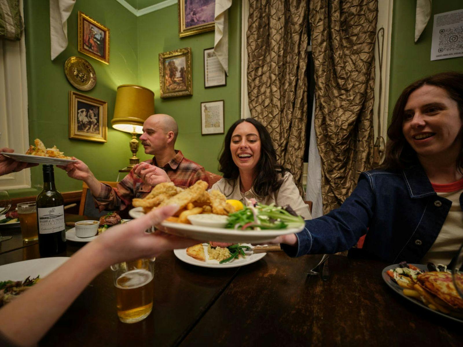 People sitting at a table enjoying a pub meal