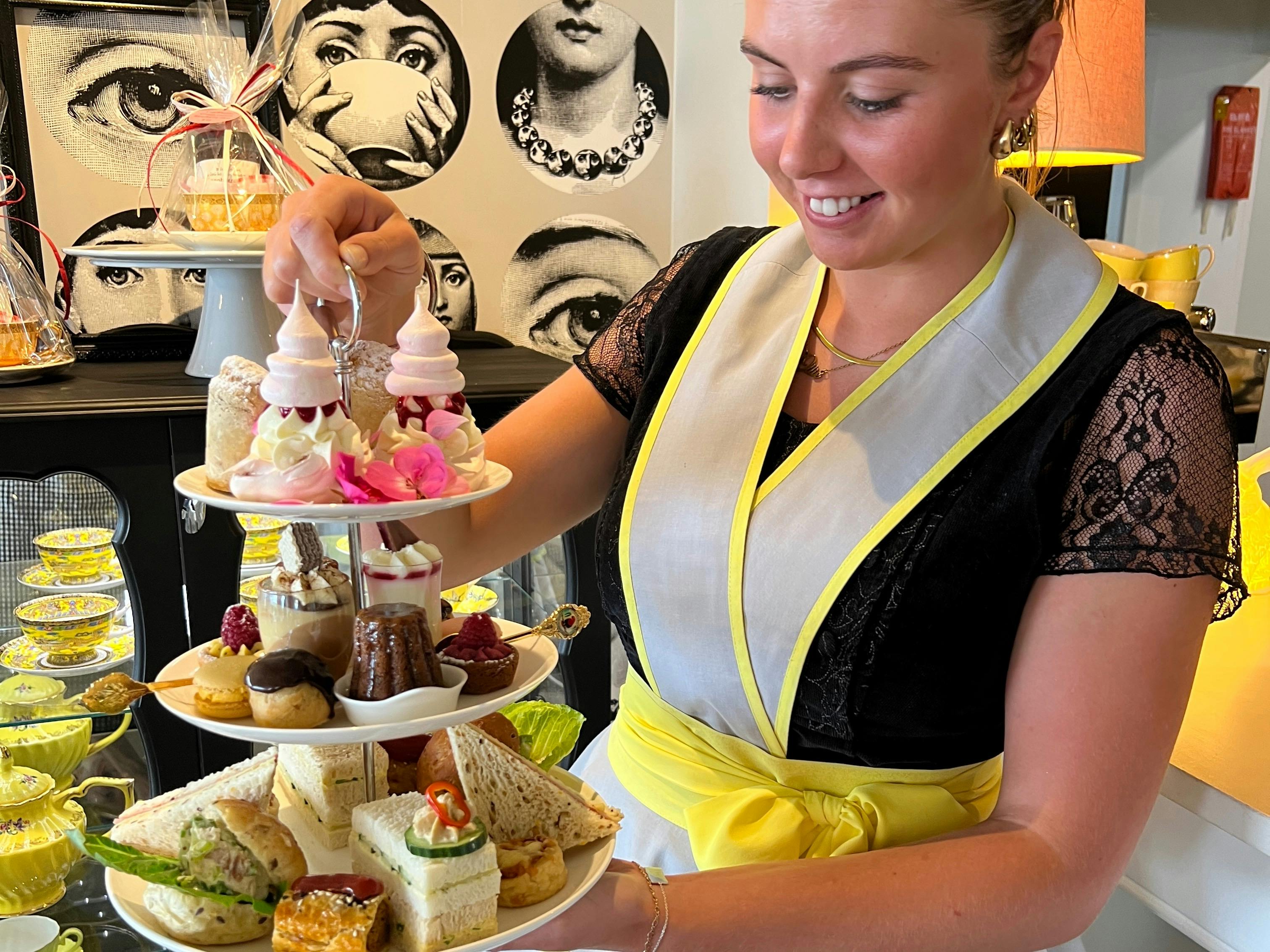 Waitress holding high tea stand