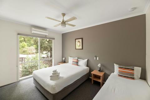 Twin guest room with queen bed, single bed and natural outlook