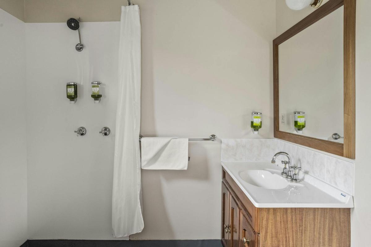 Private en-suite bathroom with accessible shower and vanity