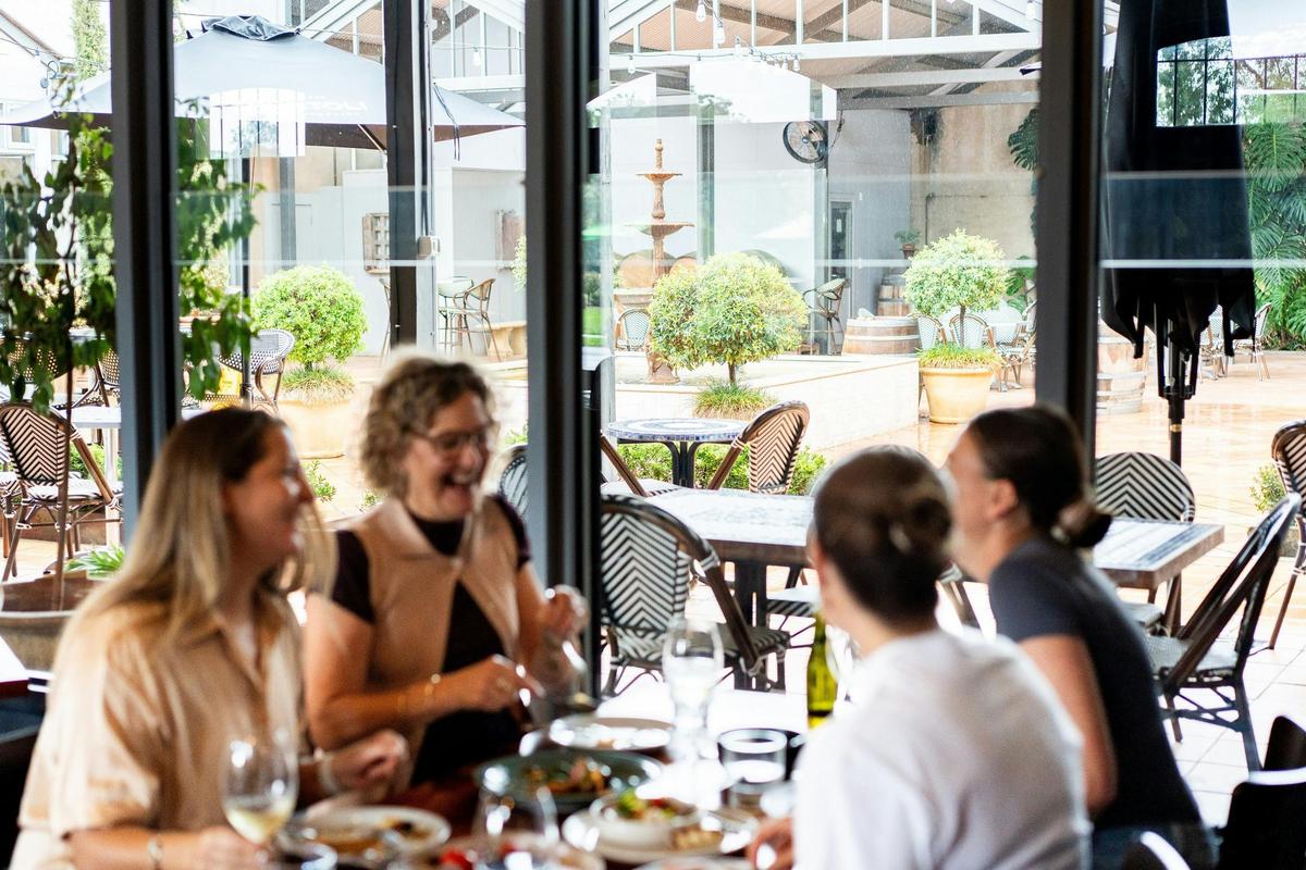 Ladies didning at Tuileries Restauarant with couryatd in background