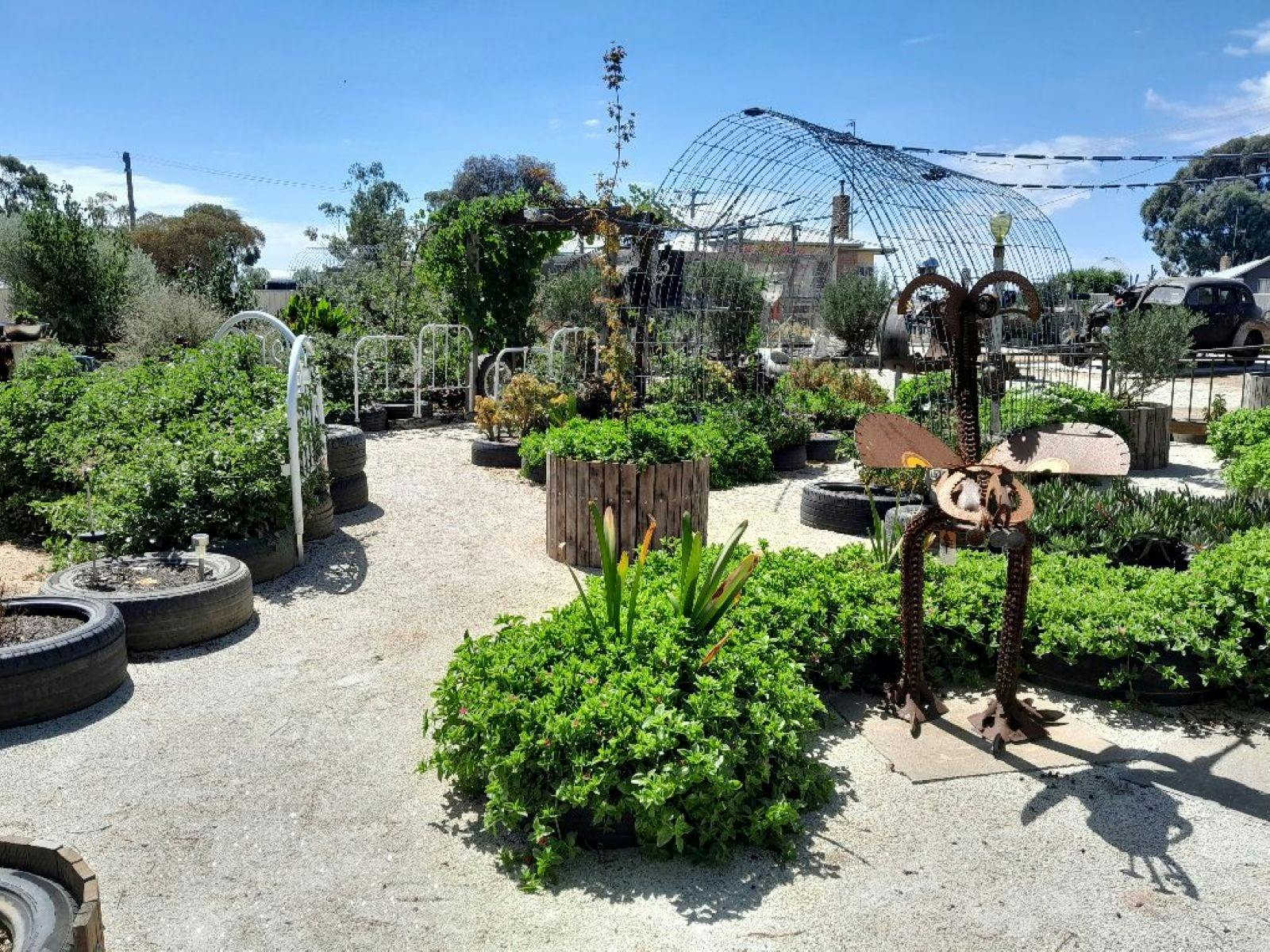Photo of a wide pathway through a manicured garden