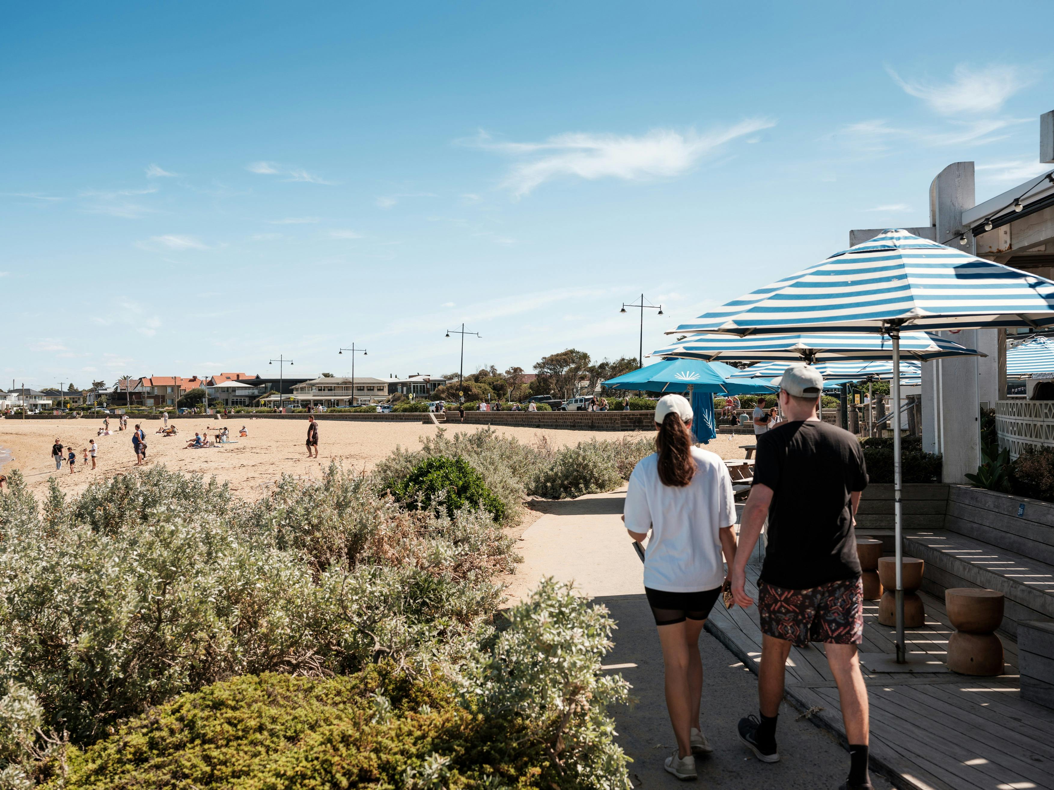 Walkers along Williamstown Beach