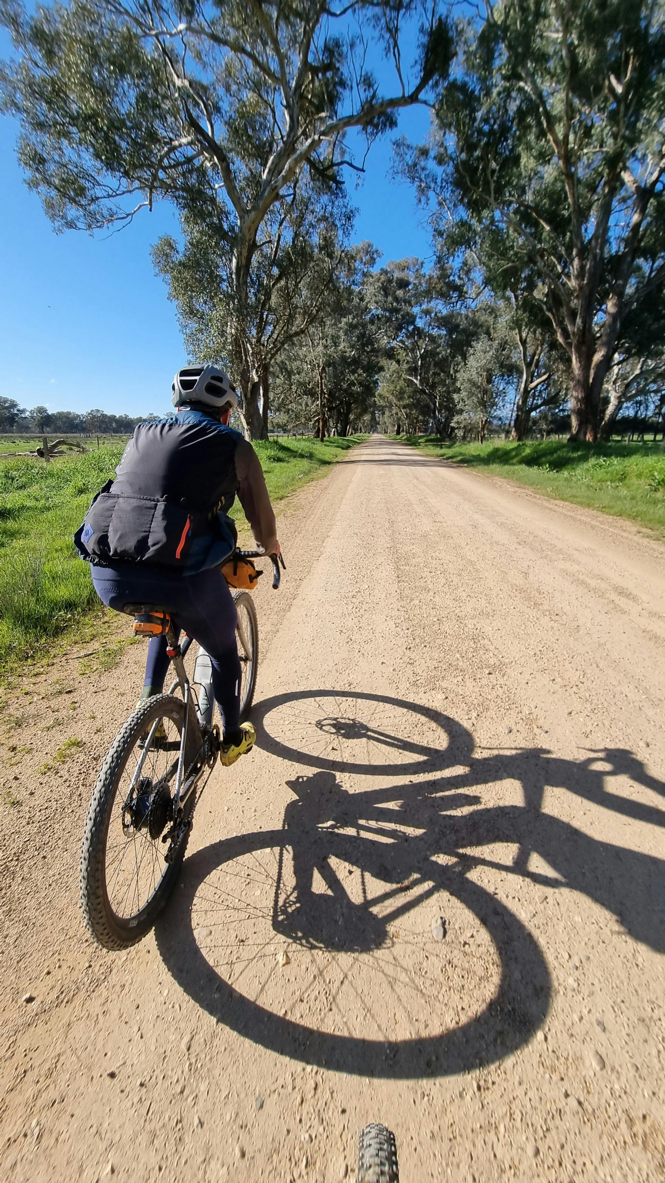 Cyclist on Gravel Road