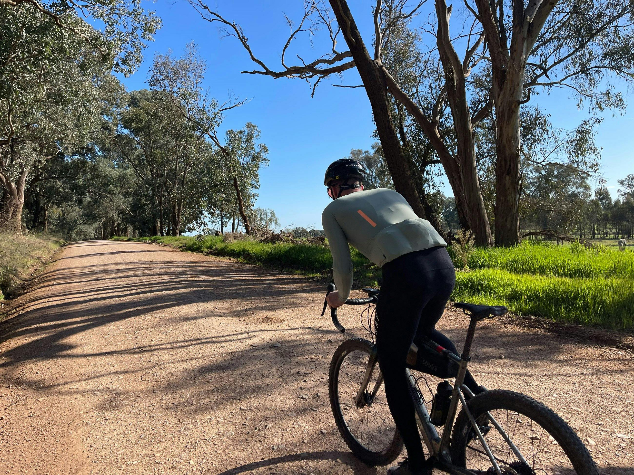 Cyclist on Gravel Road