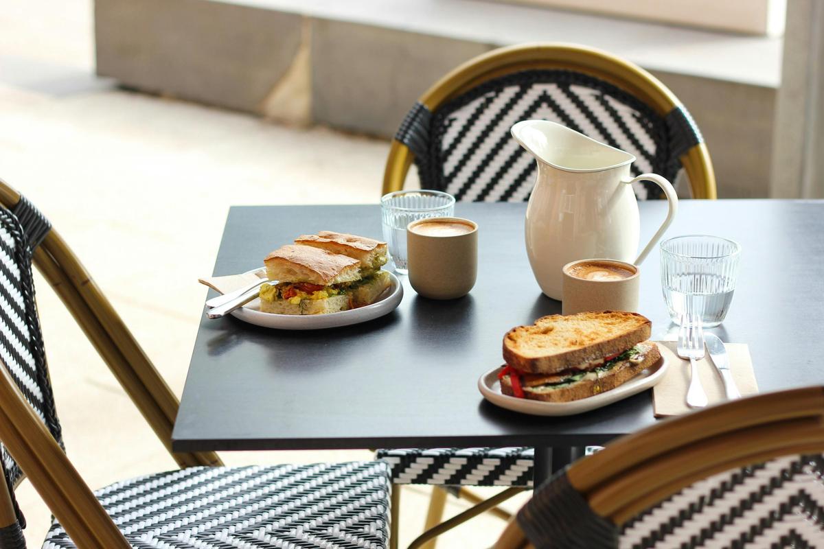 Sandwiches and coffees on a provincial table outside on the terrace