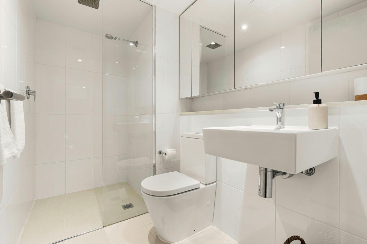 Sleek and modern bathroom with a spacious shower and minimalist design.