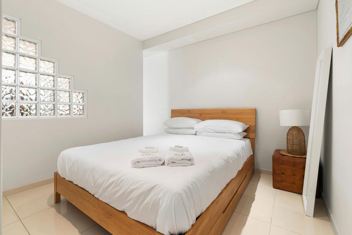 Cozy and modern bedroom with a minimalist design and natural light.