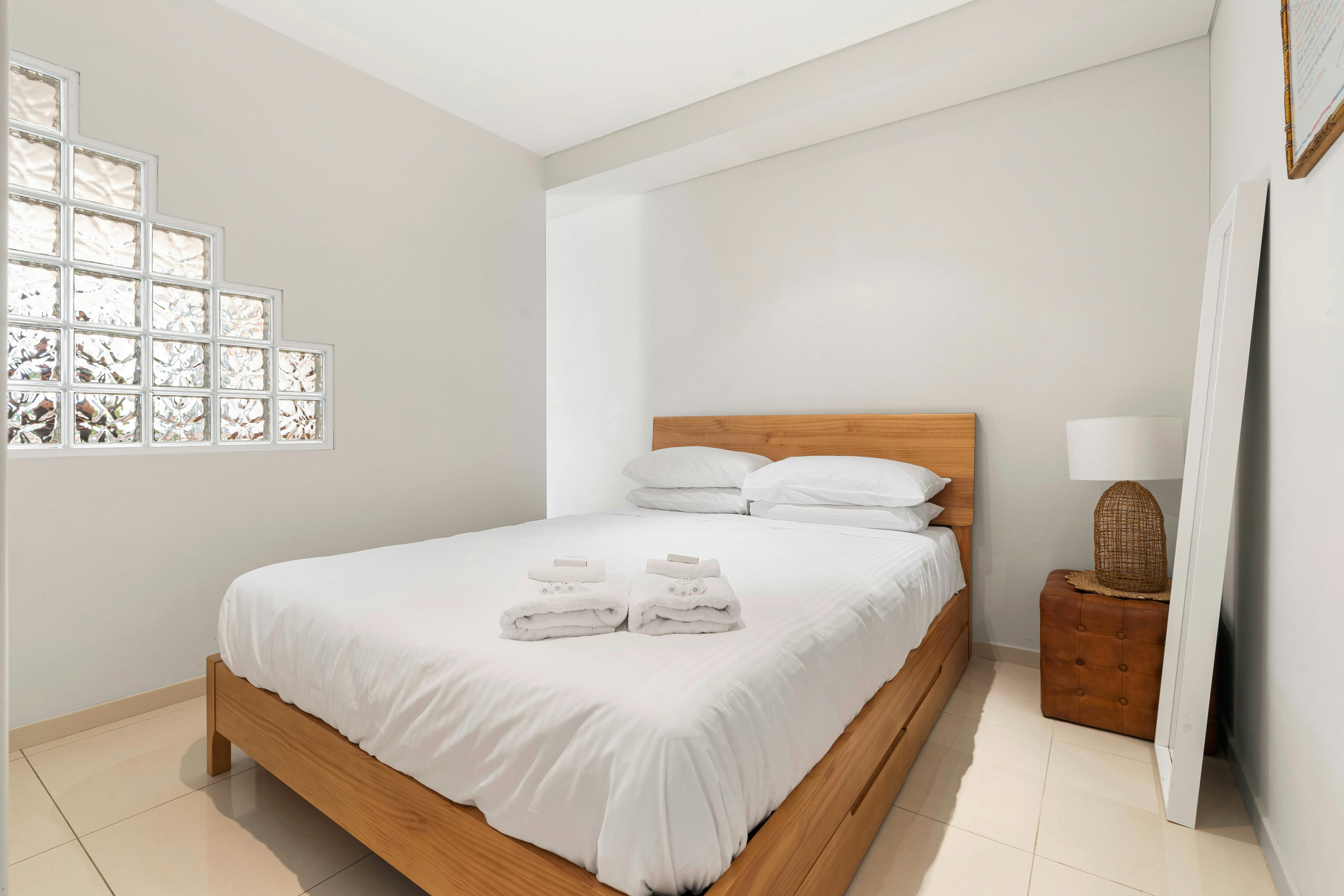 Cozy and modern bedroom with a minimalist design and natural light.