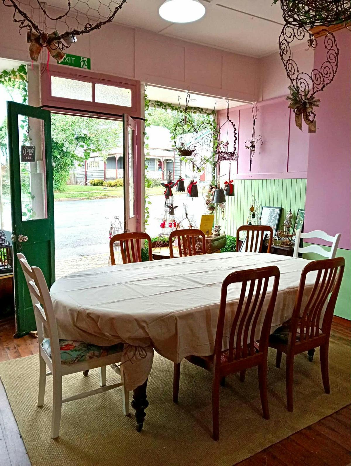 Interior of the studio looking out the front window. One of the large worktables and chairs
