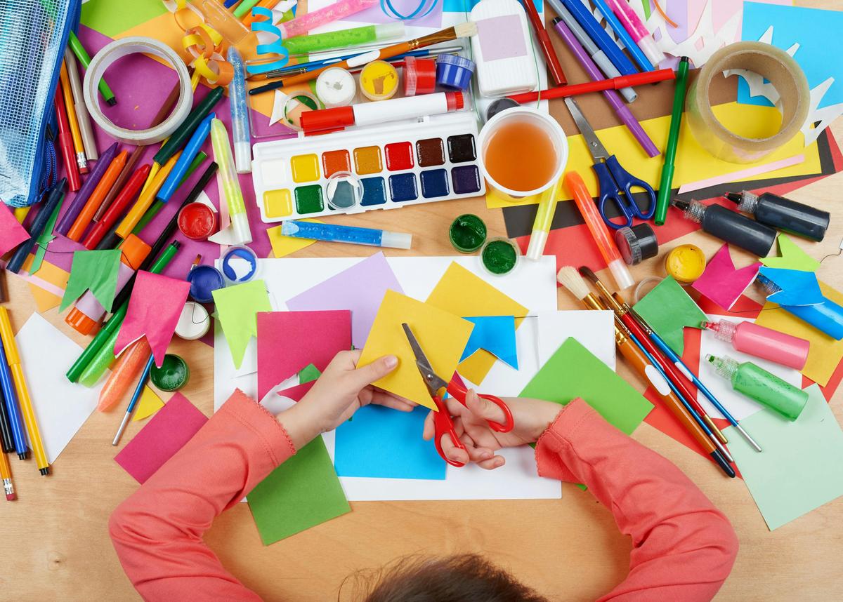A child works with a variety of craft materials