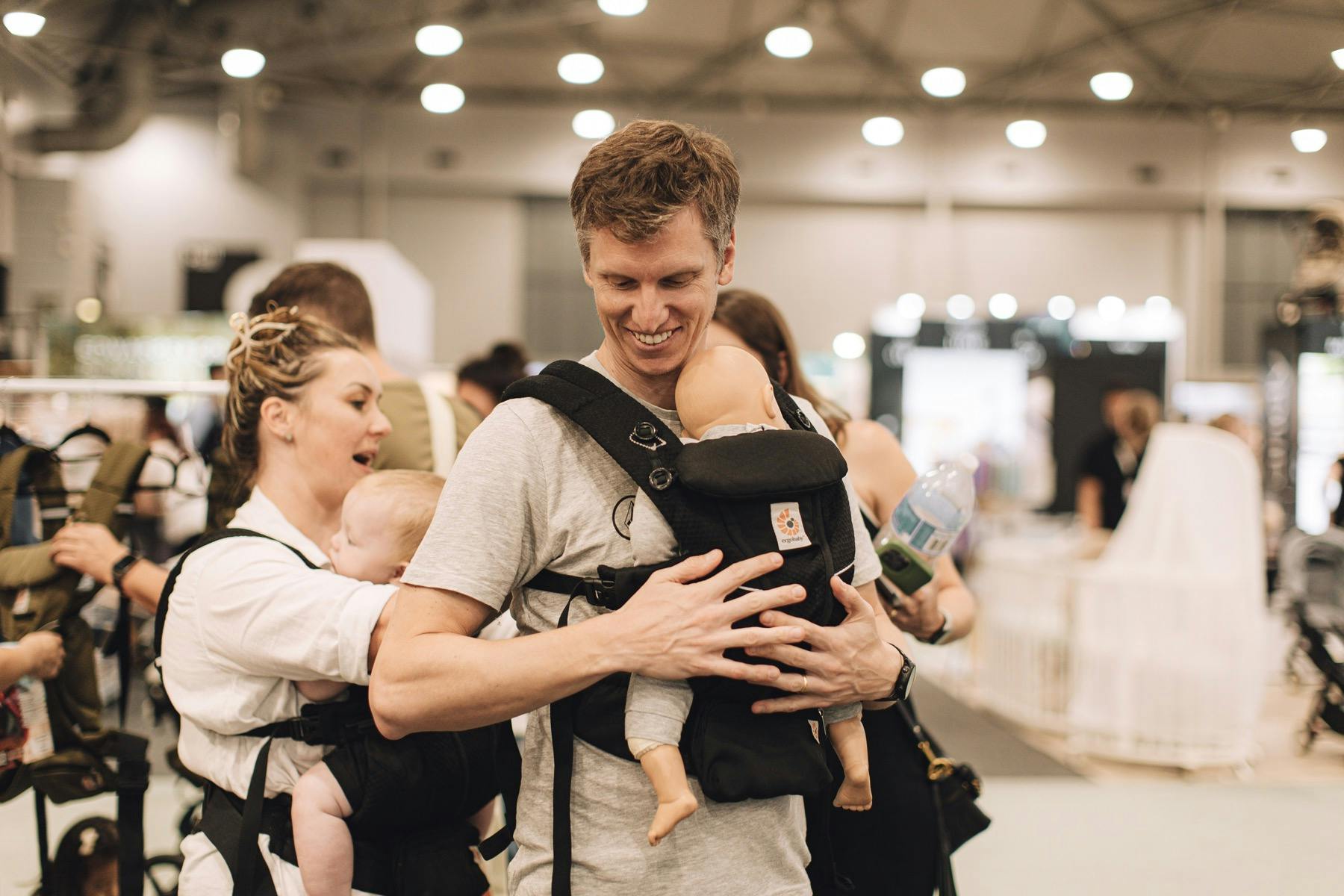 Dad-to-be testing baby wearing at PBC BABY Expo