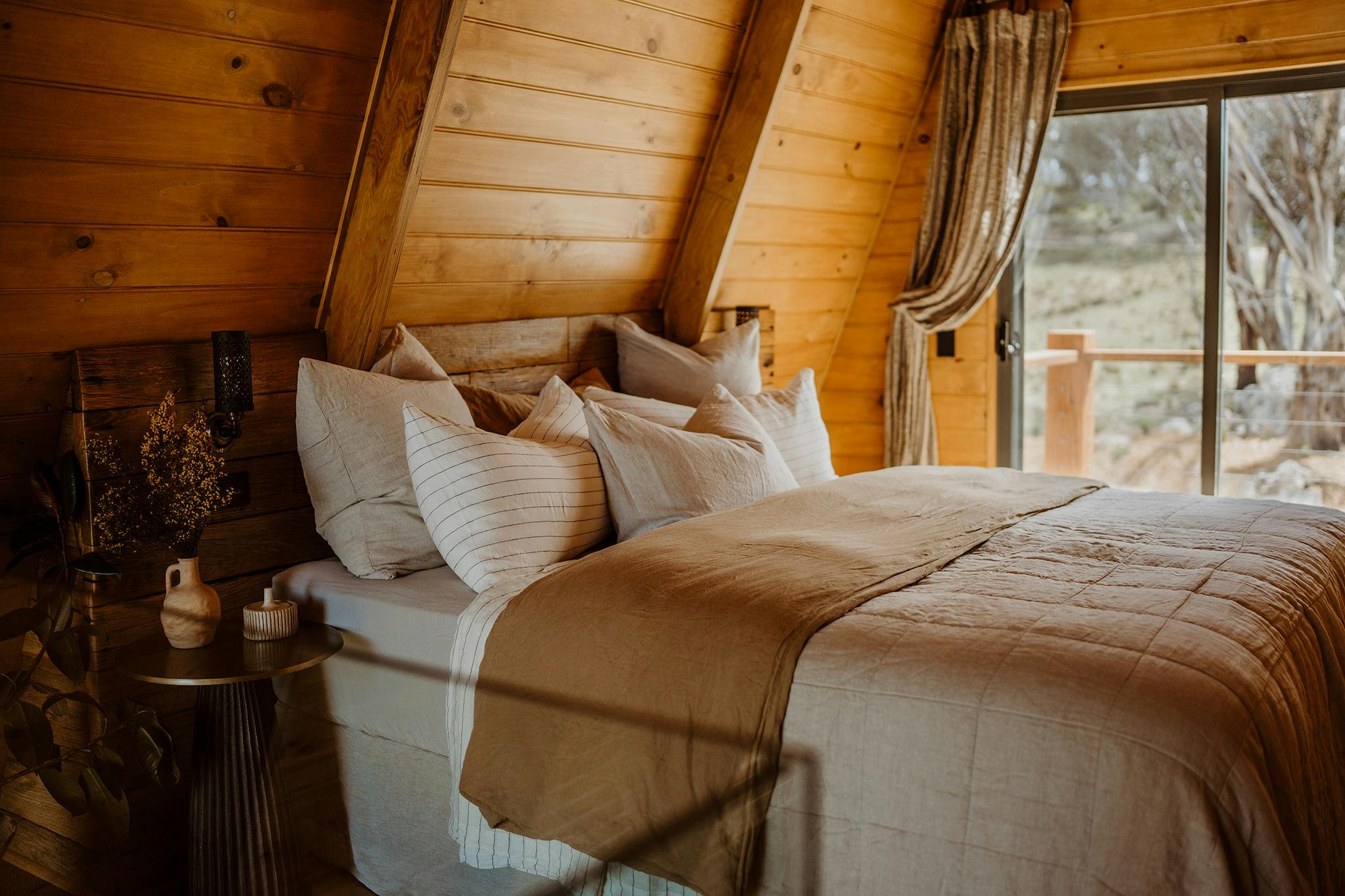 Sleep in style and comfort in the Riverview A-Frame bedroom, featuring a king-size bed