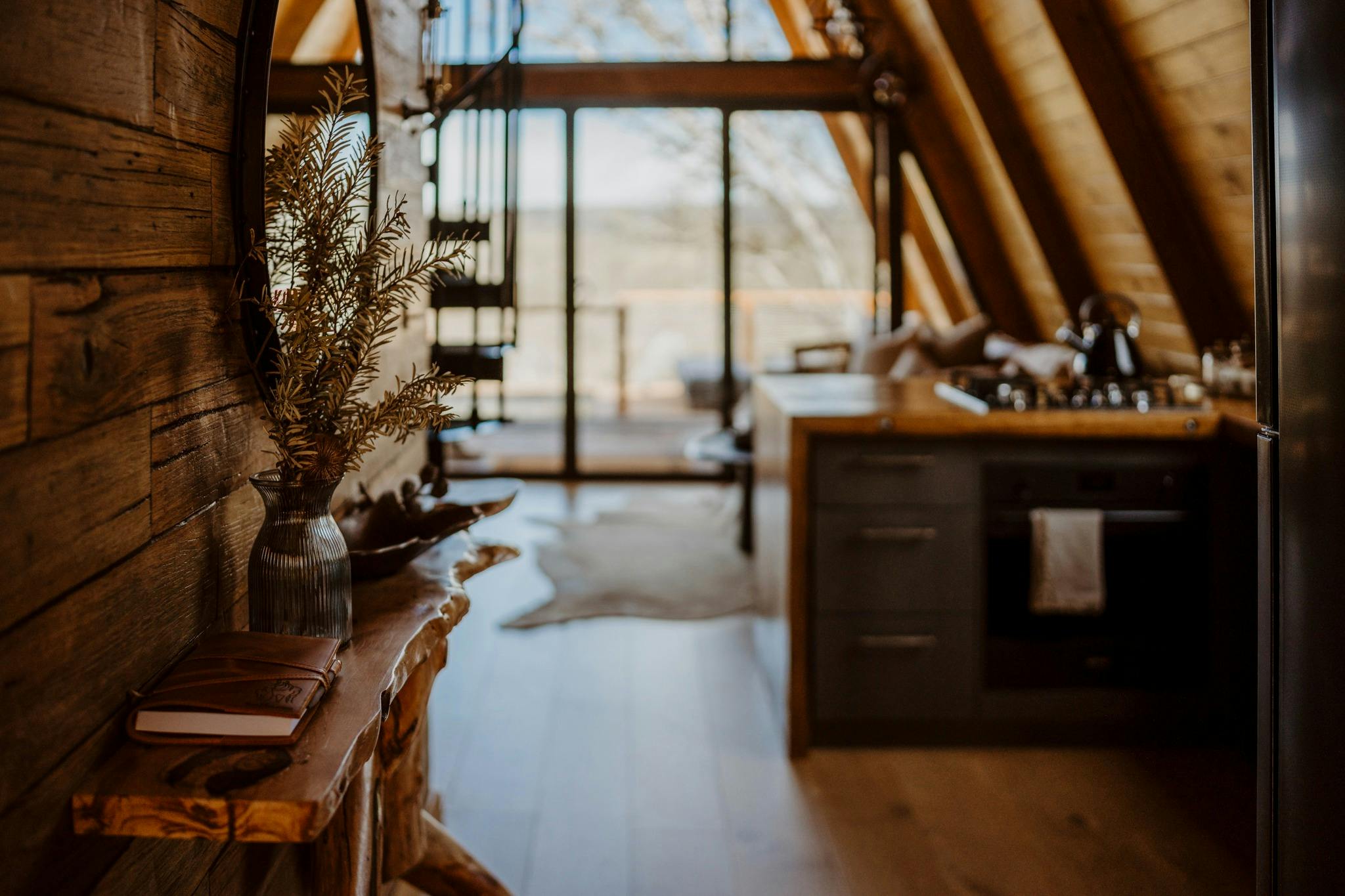 Riverview A-Frame cabin kitchen with handmade wooden benchtop, timber walls and console table