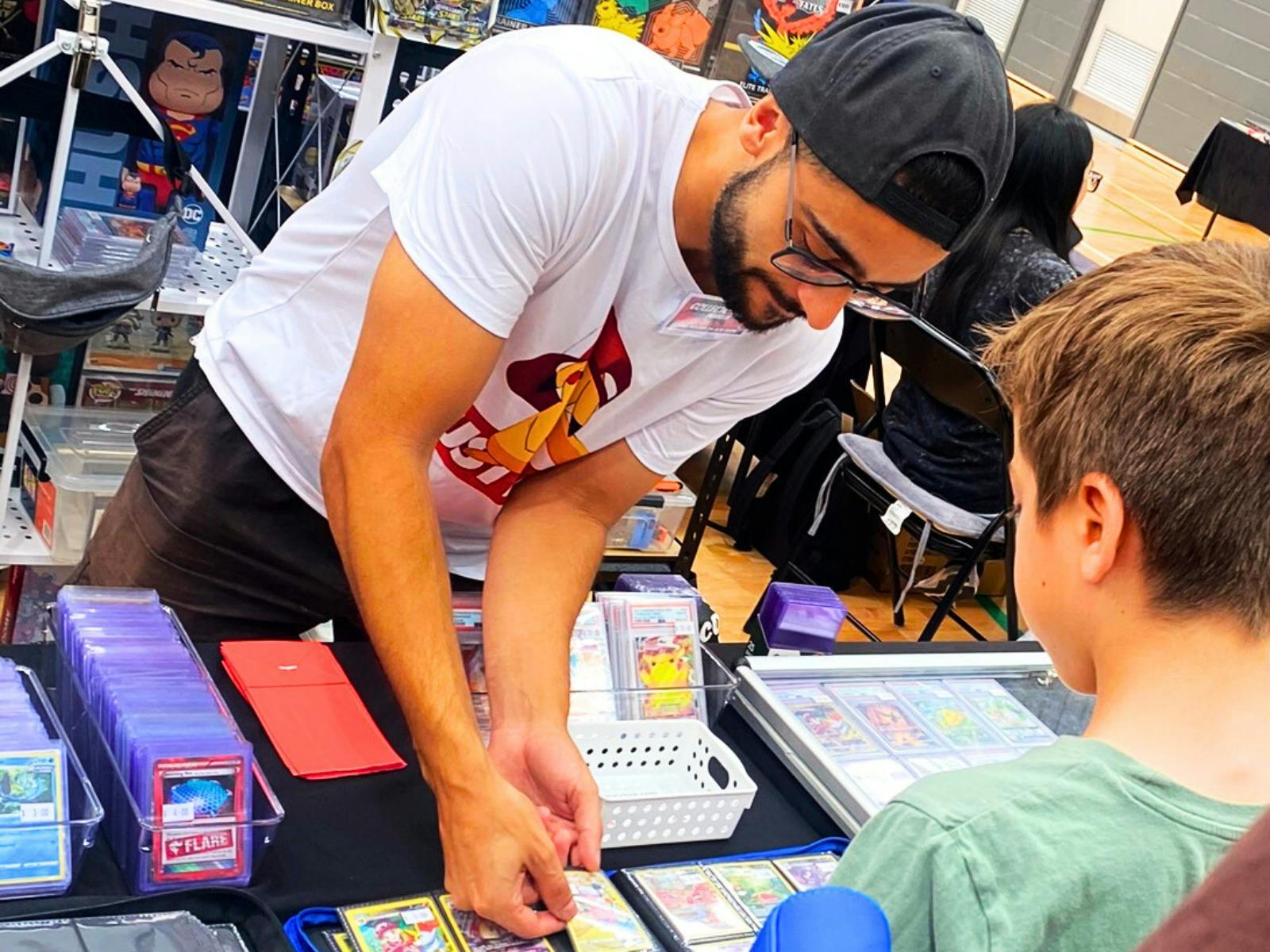 TCXPO - Trading Card Expo - vendor assisting attendee with trading cards