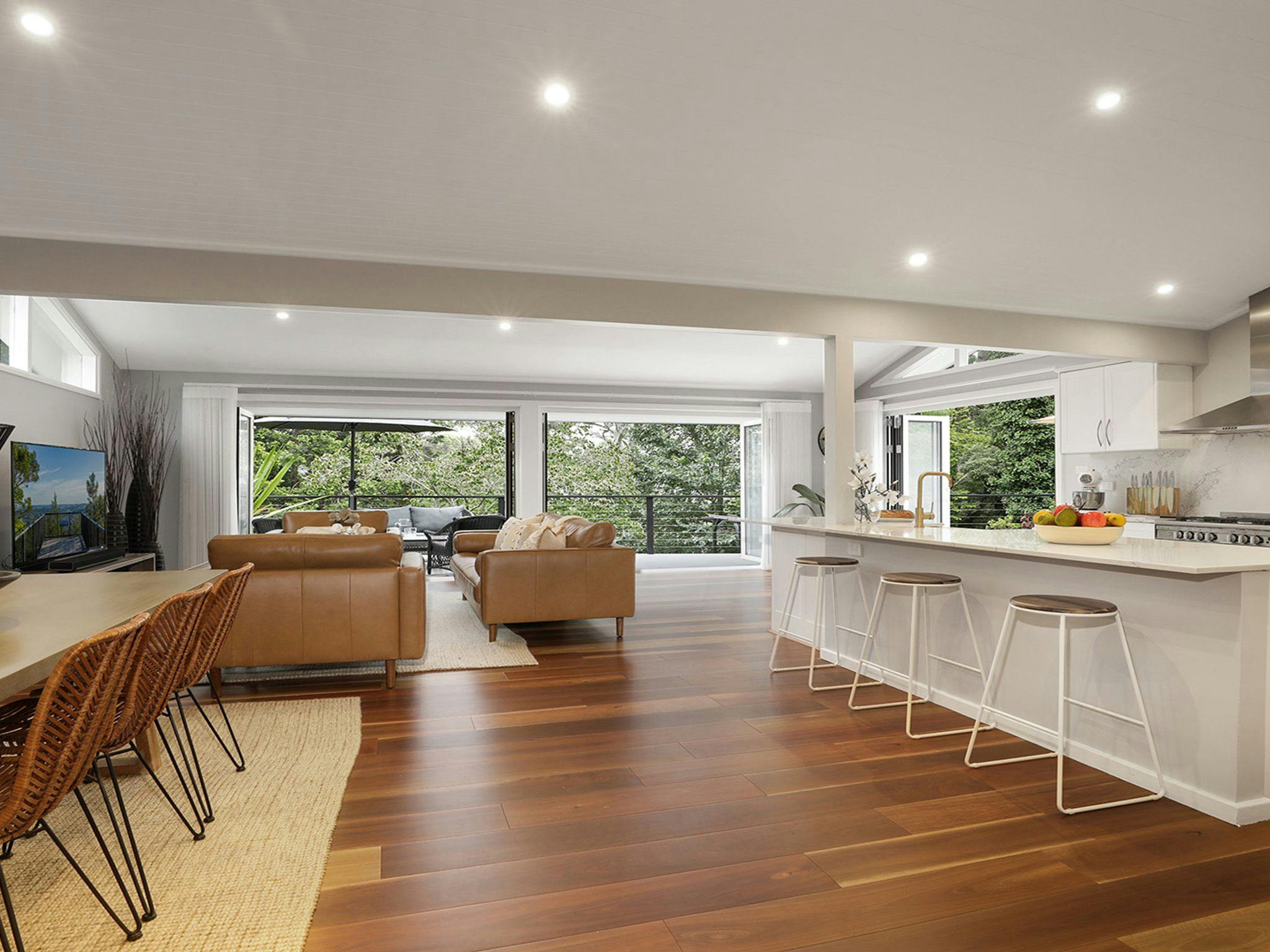 Arcadia Cottage | Dining area in open plan room with kitchen and living area | Back doors open onto 