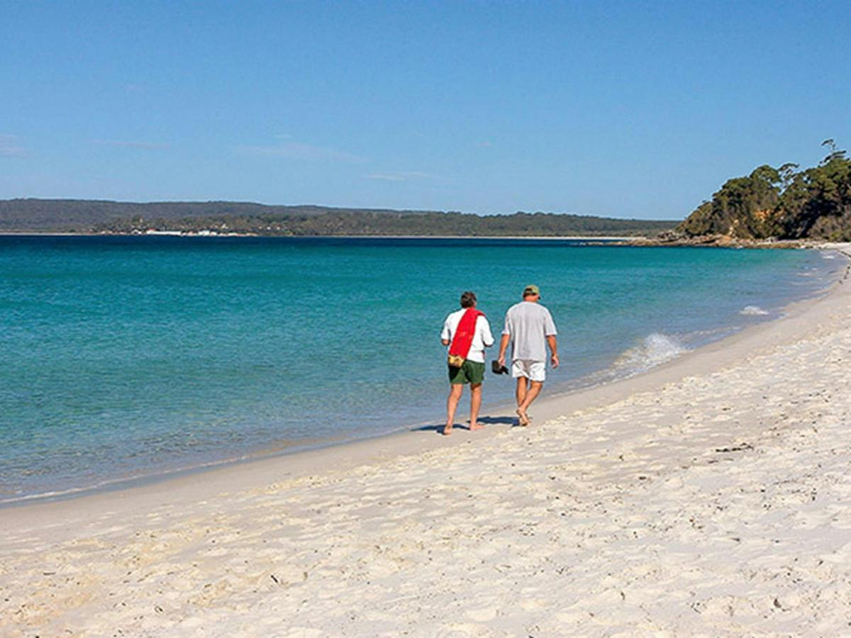Two men walk along Hyams Beach, Jervis Bay National Park. Photo: Michael Van Ewijk © DPIE