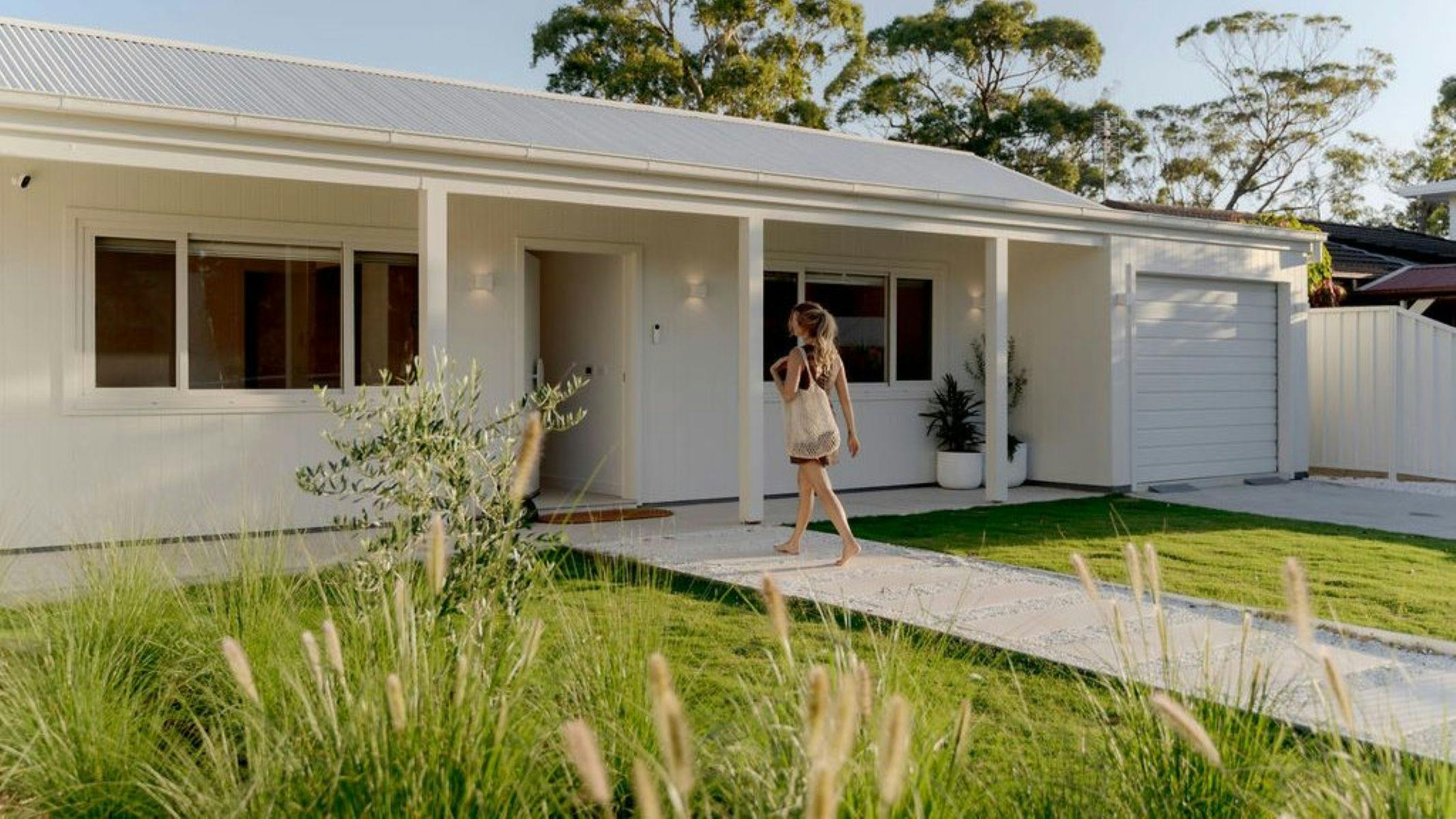 Charming from the street, this new white cottage reveals a striking surprise the moment you walk in.