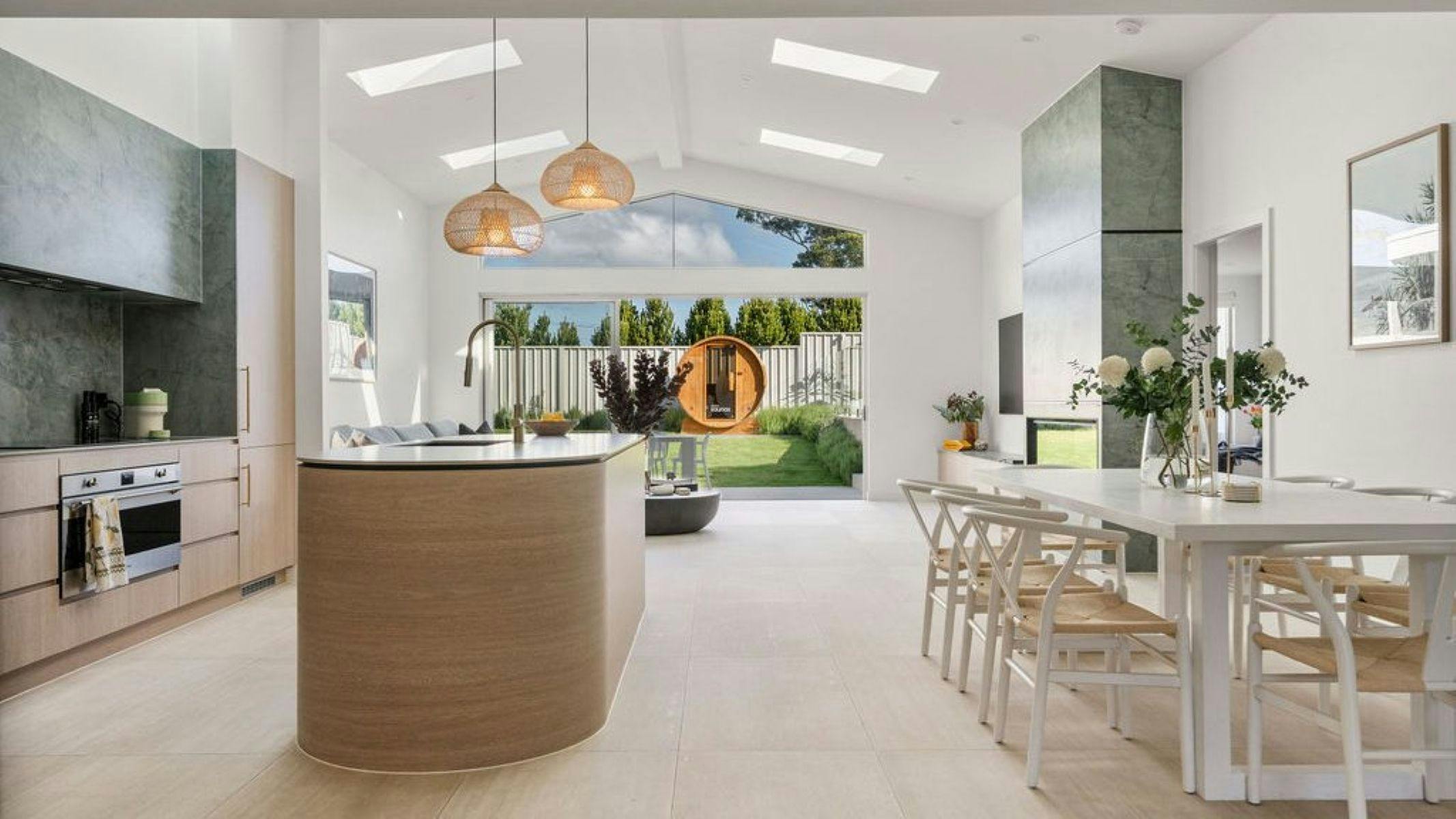 Natural light fills the interiors, highlighting a calm palette of whites and soft textures.