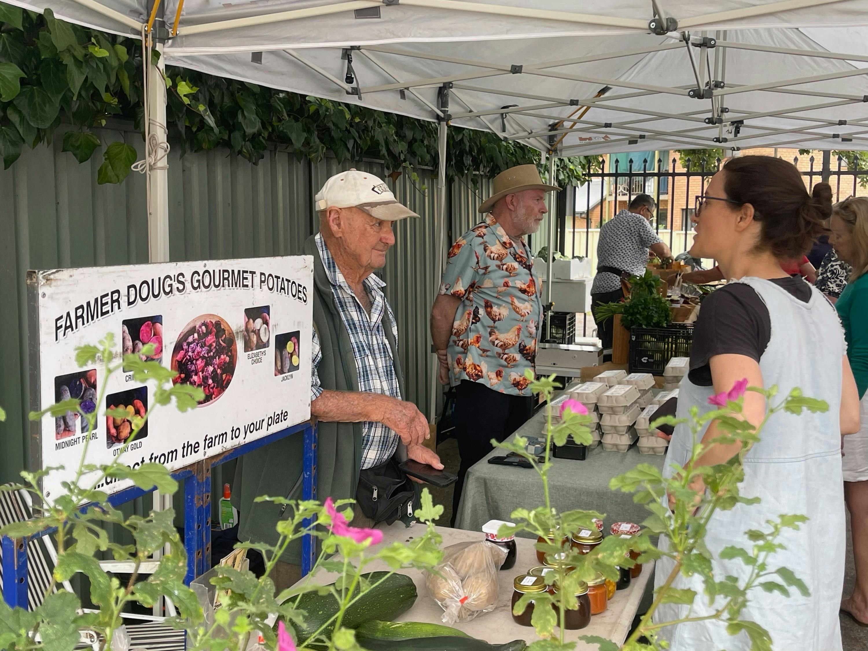 Farmer Doug, a local legend, chatting with a regular customer.