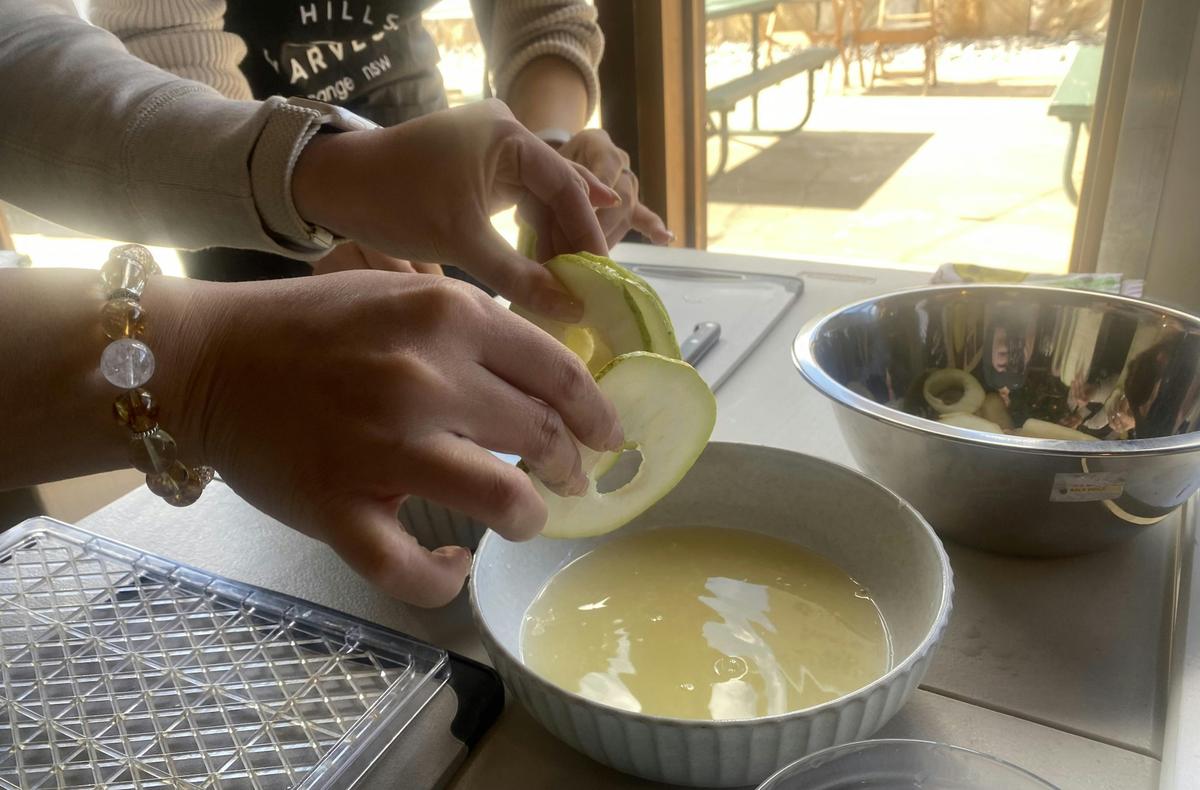 dipping apple slices in lemon juice