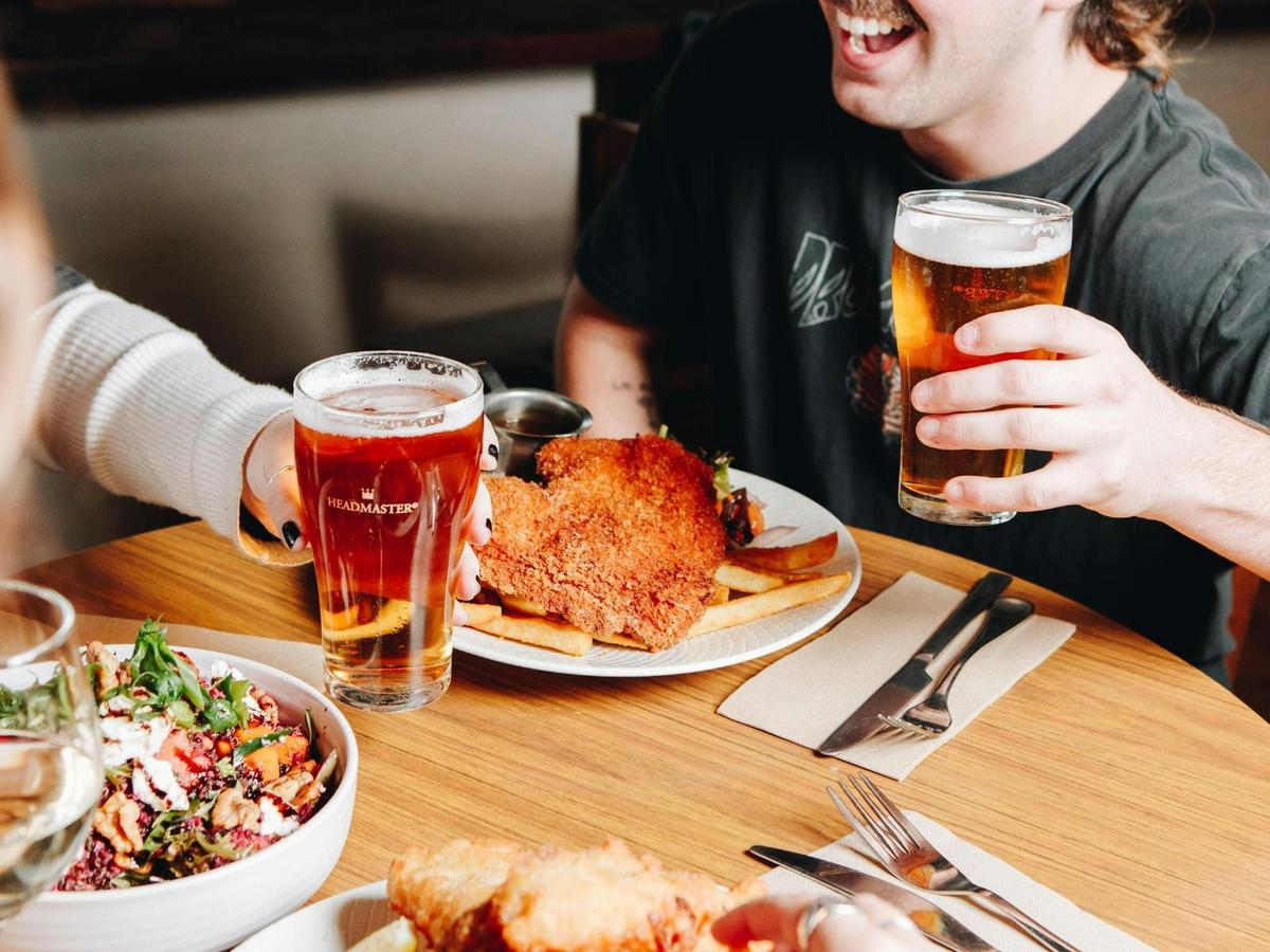 Chicken schnitzel with chips served with beers.