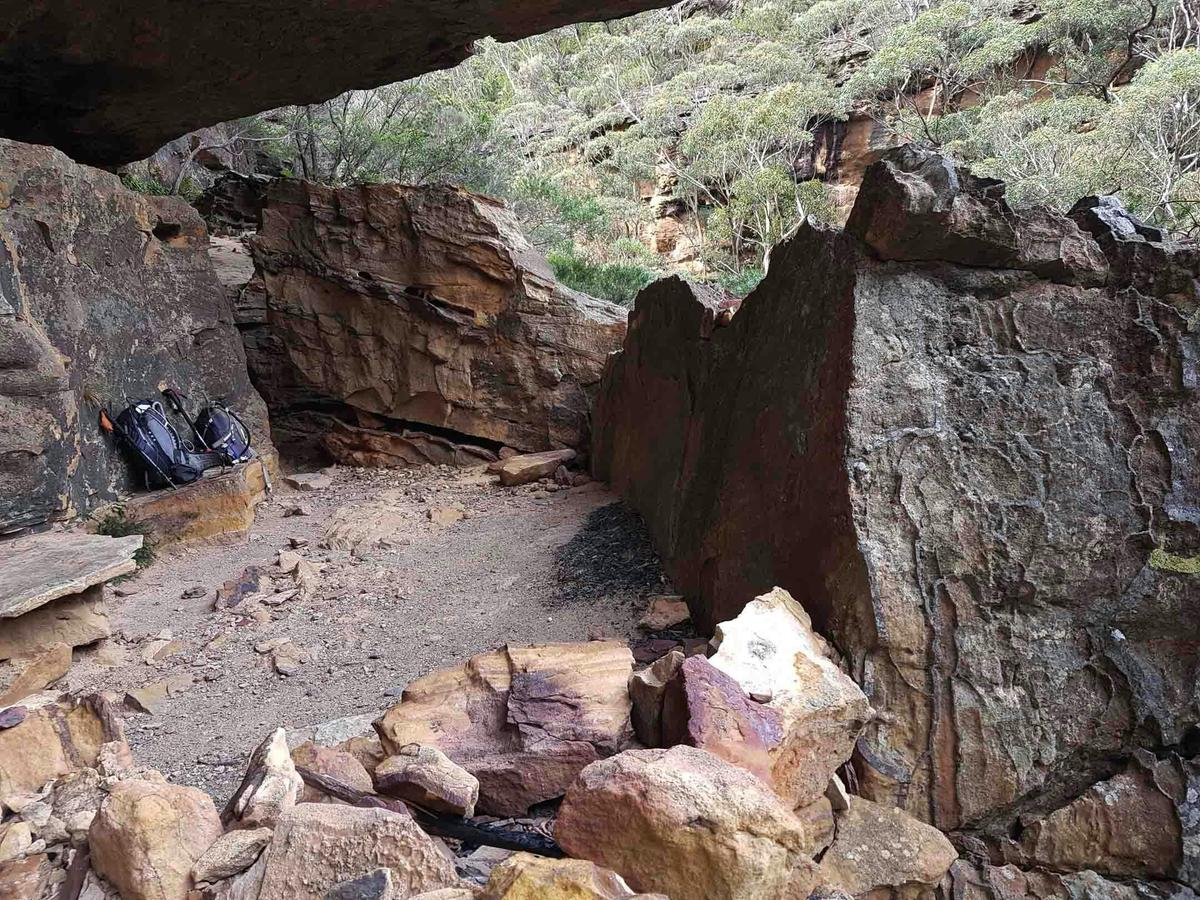 Resting in the kitchen - putting down our packs in the former cooking area at Darks Cave.