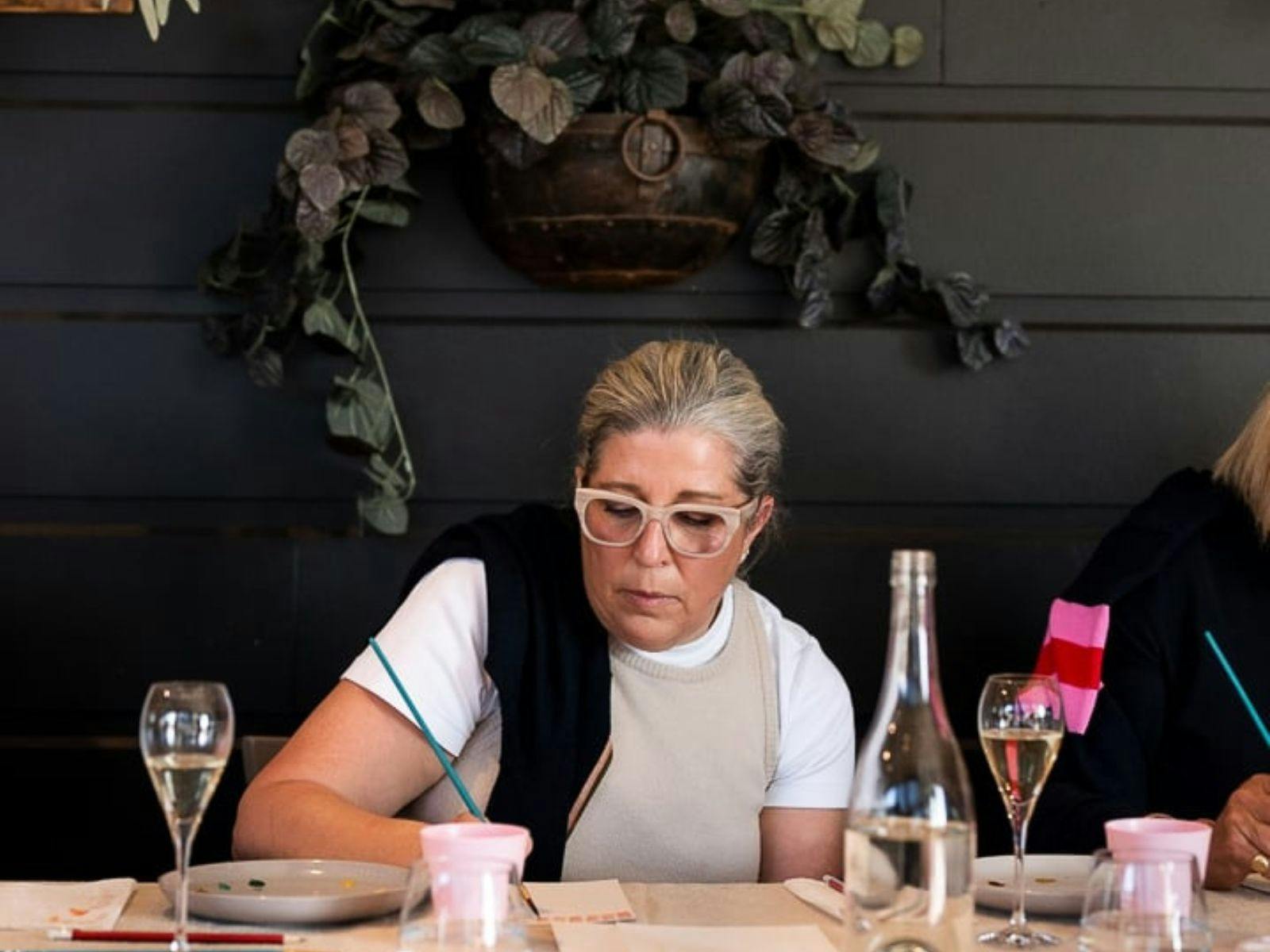 Woman painting at a watercolour workshop in orange at Heifer Station winery