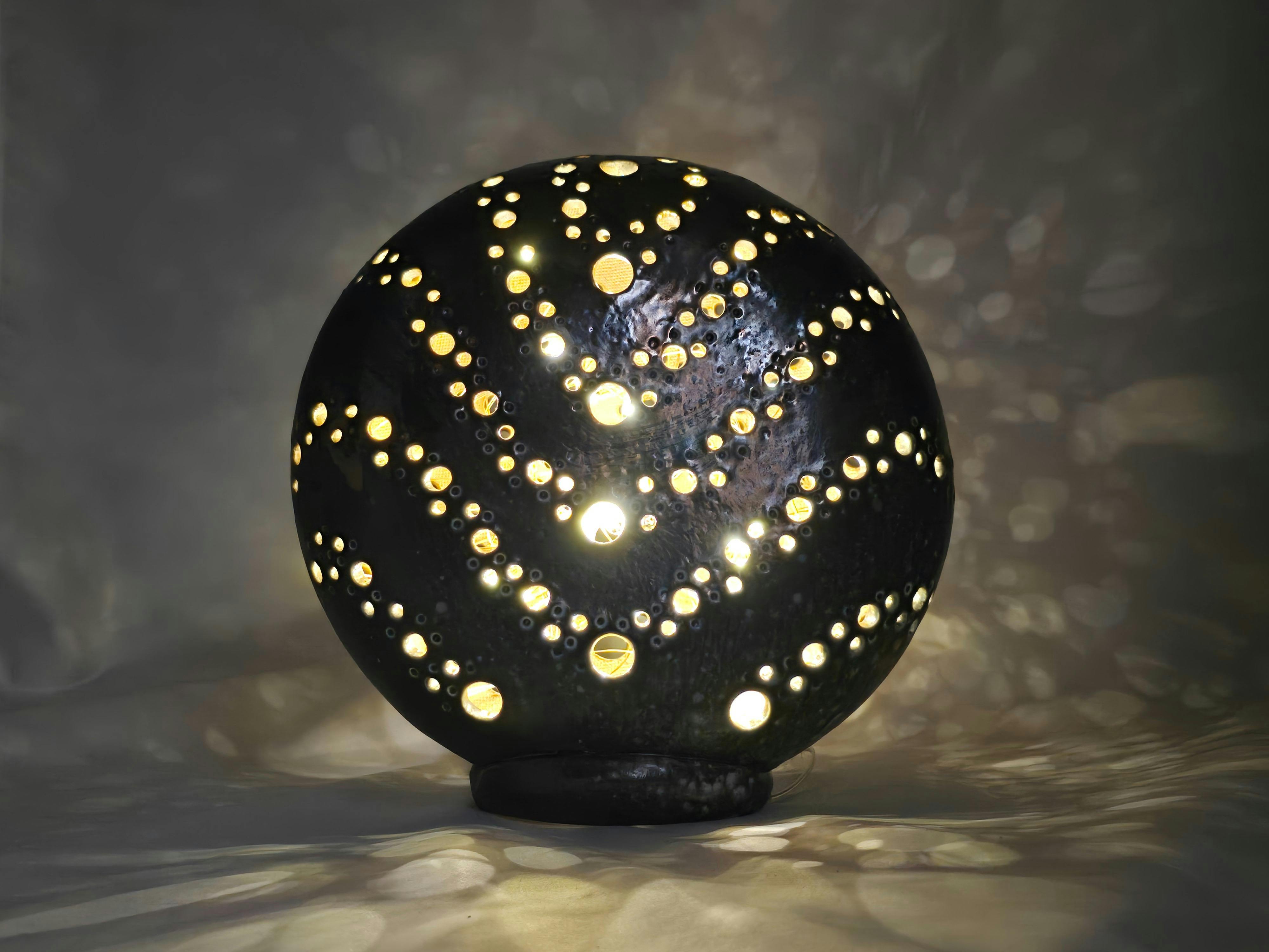 Ceramic lanterns glow with warm light, creating a calm, relaxing atmosphere, by Colette Steindl