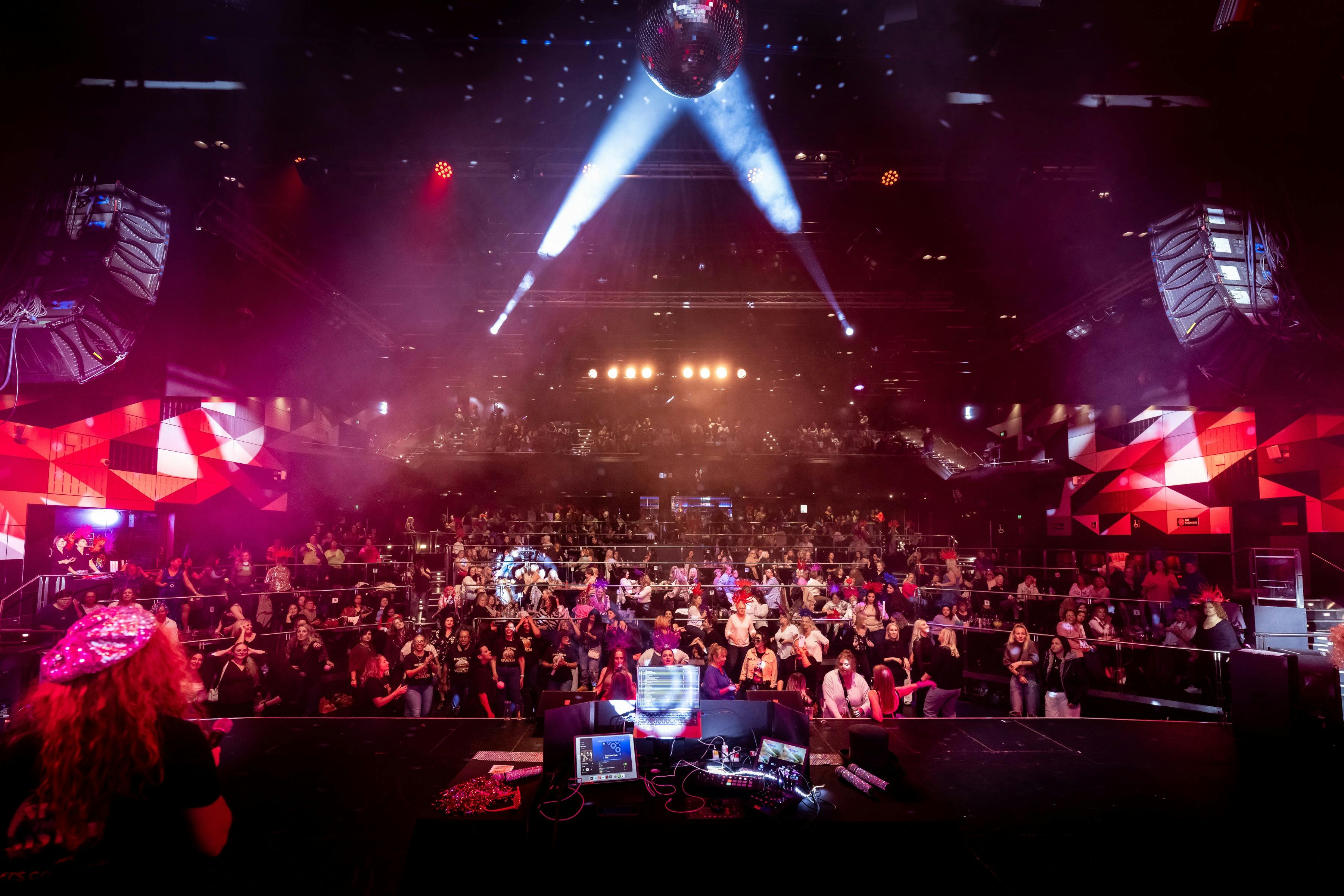 From the stage, a perspective photo of a huge crowd with stage lighting all around