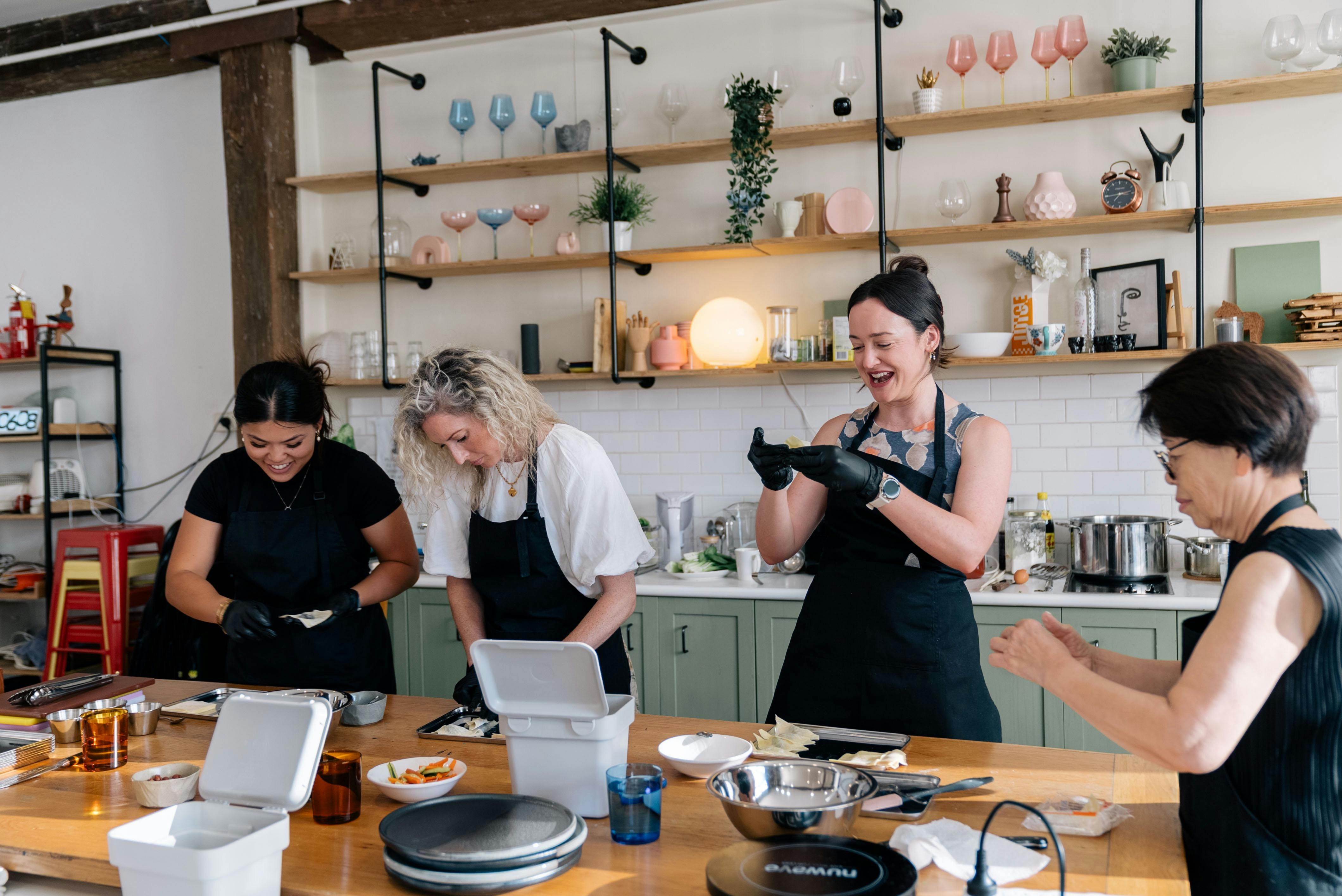Class members folding dumplings