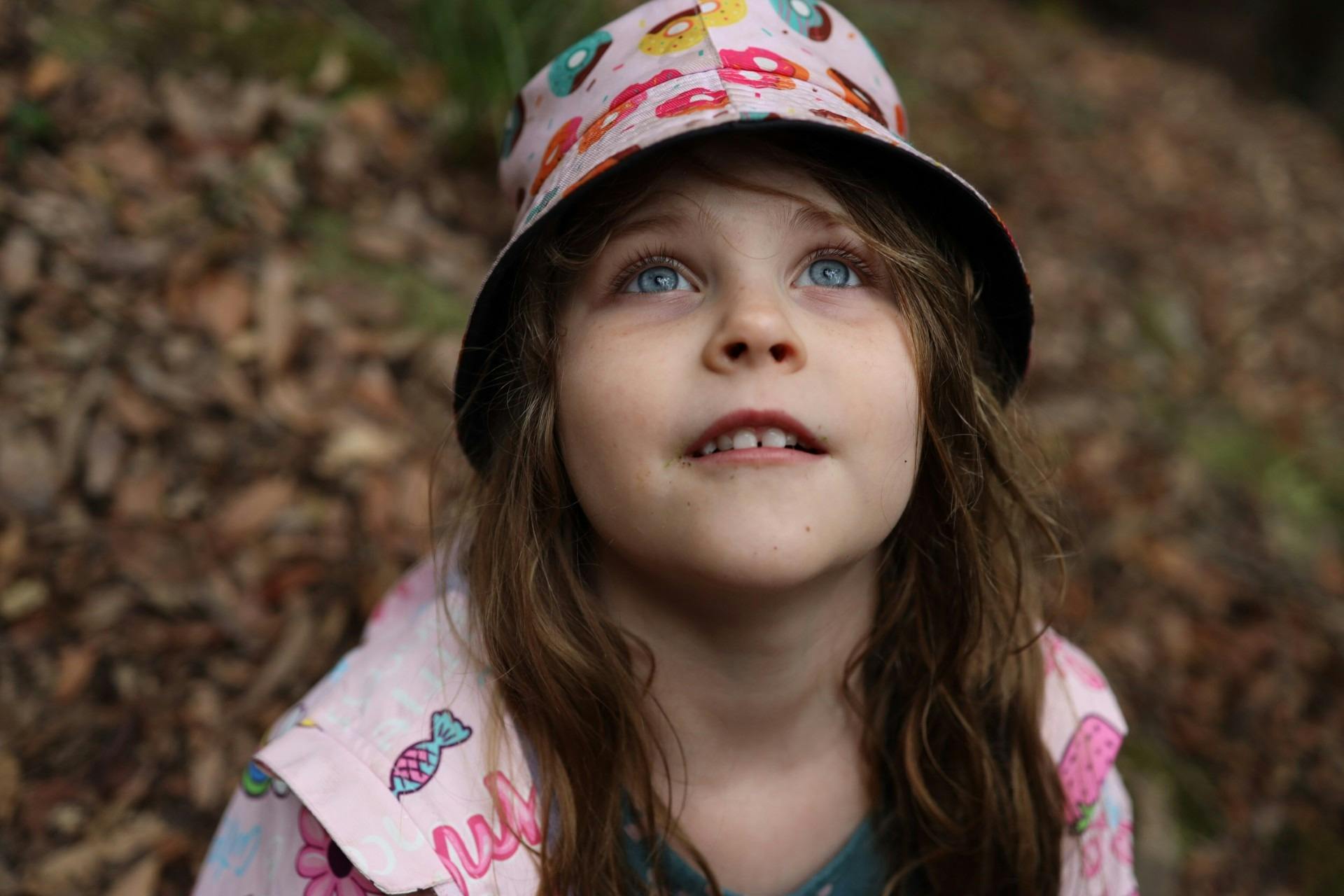 Young girl in nature looking up