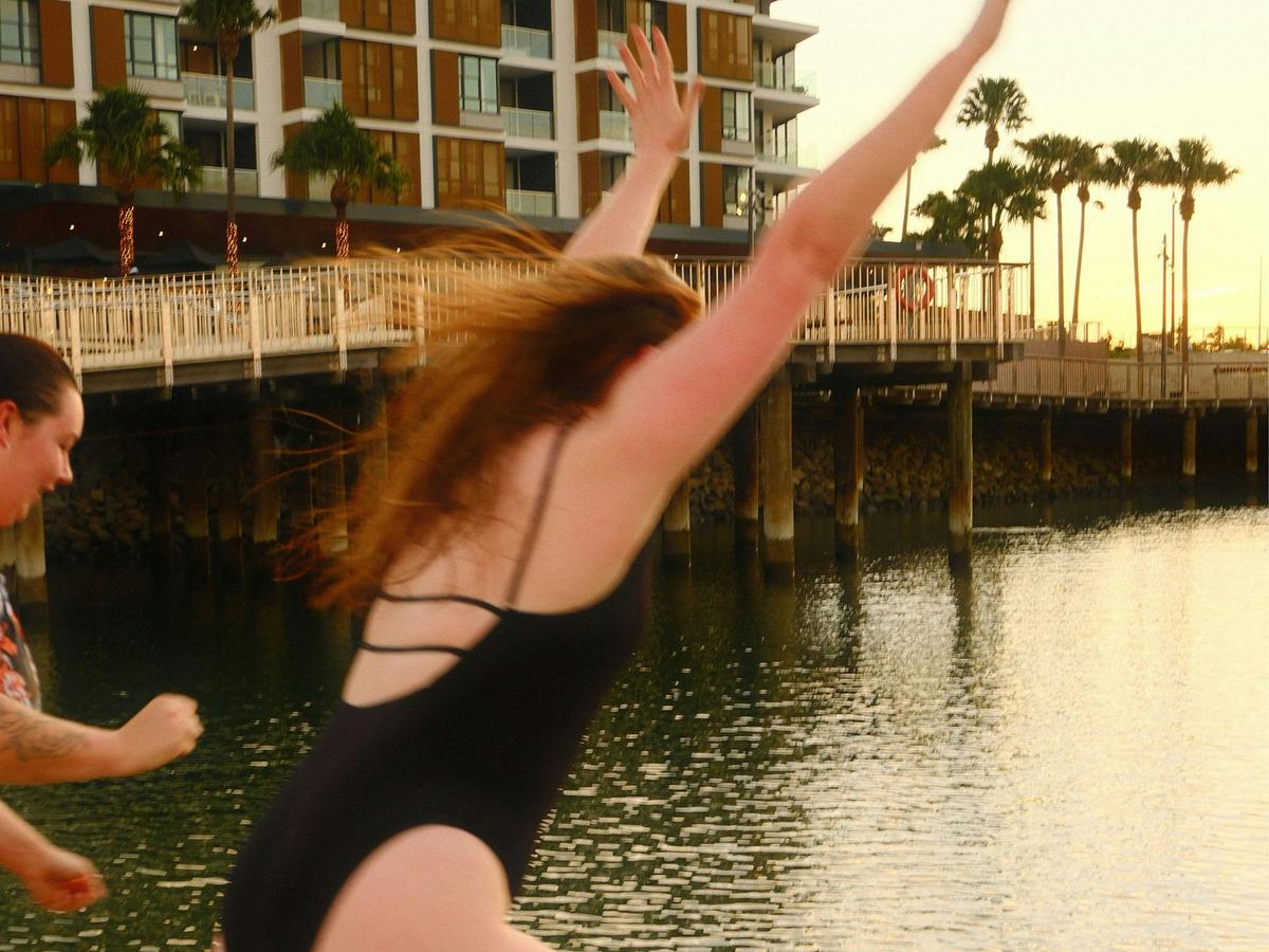 Girls jumping into the water