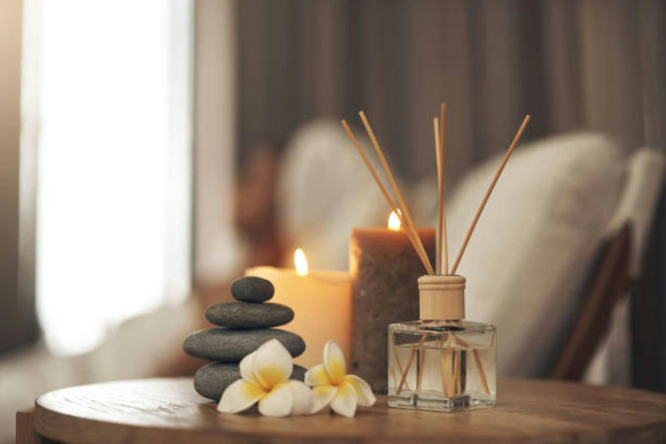 incense sticks, candles burning, stones stacked