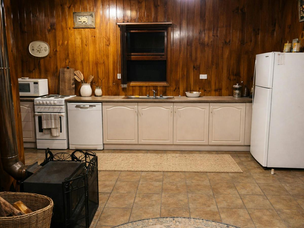 A rustic timber-lined country kitchen with everything needed for a comfortable stay