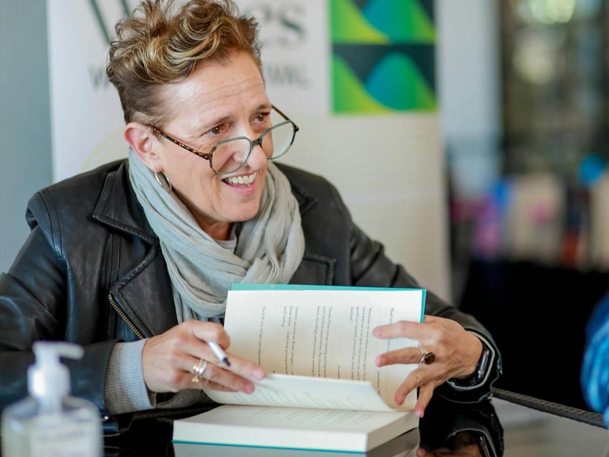 Charlotte Wood signs books for audience members