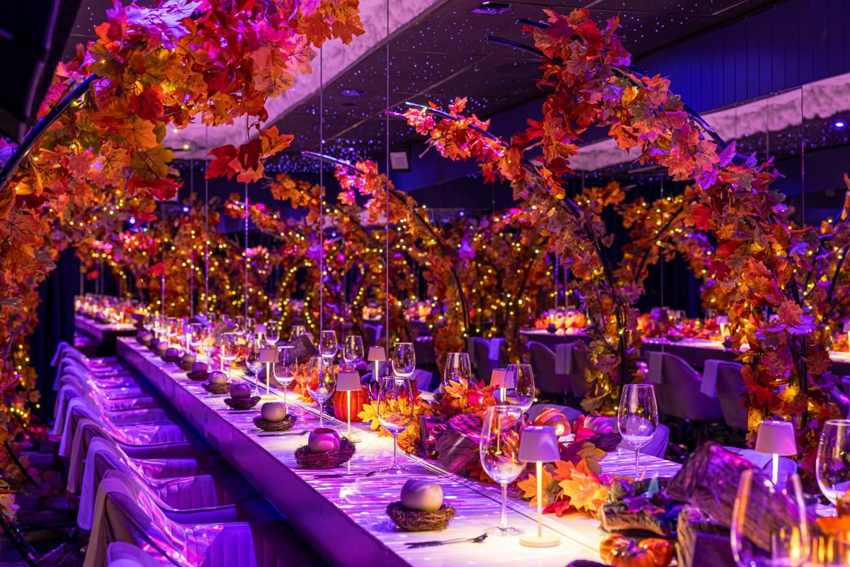 autumn season dining setting with coloured decorations and fairy lights