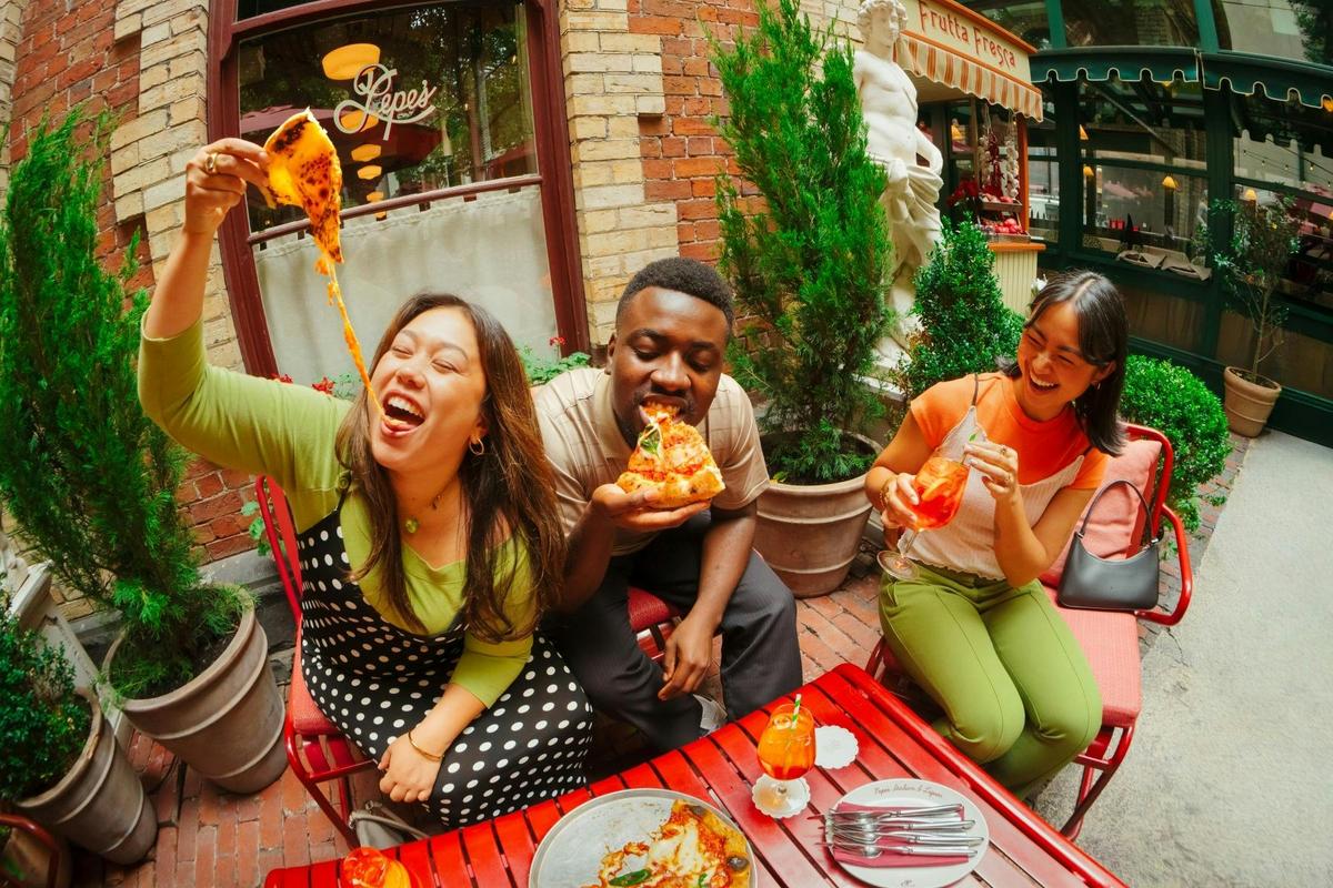 Group of friends enjoying a pizza at Pepe's Italian and Liquor