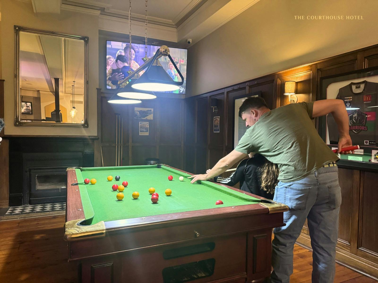 Guests enjoying a game of pool in the relaxed bar area at the Courthouse Hotel.