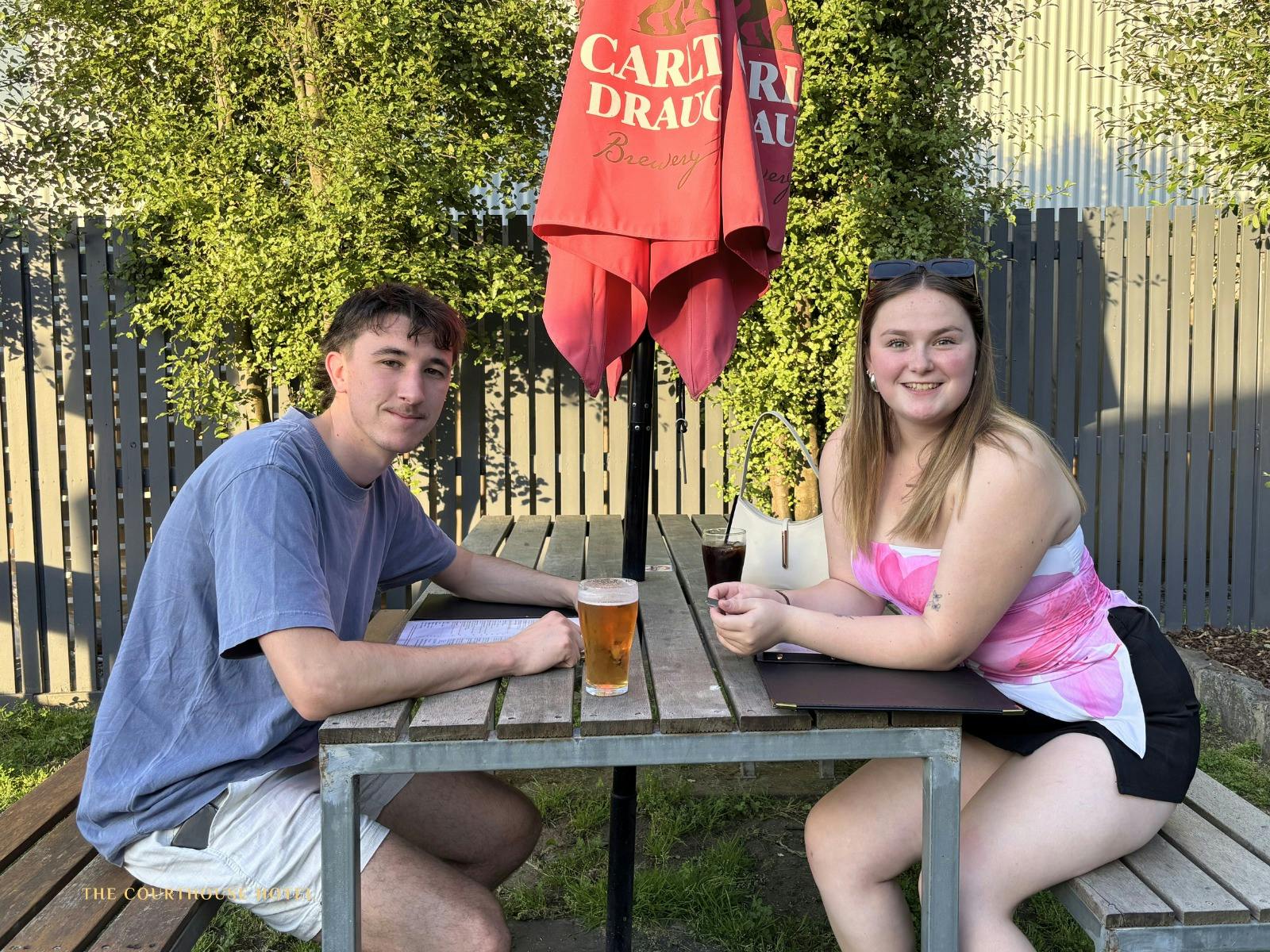 Guests enjoying drinks in the sunny outdoor beer garden at the Courthouse Hotel.