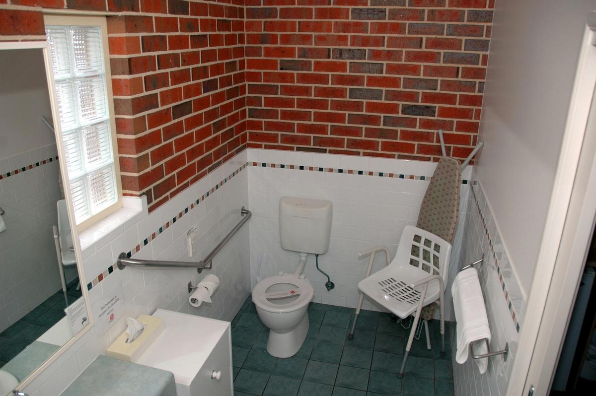 Bathroom with rails and shower chair