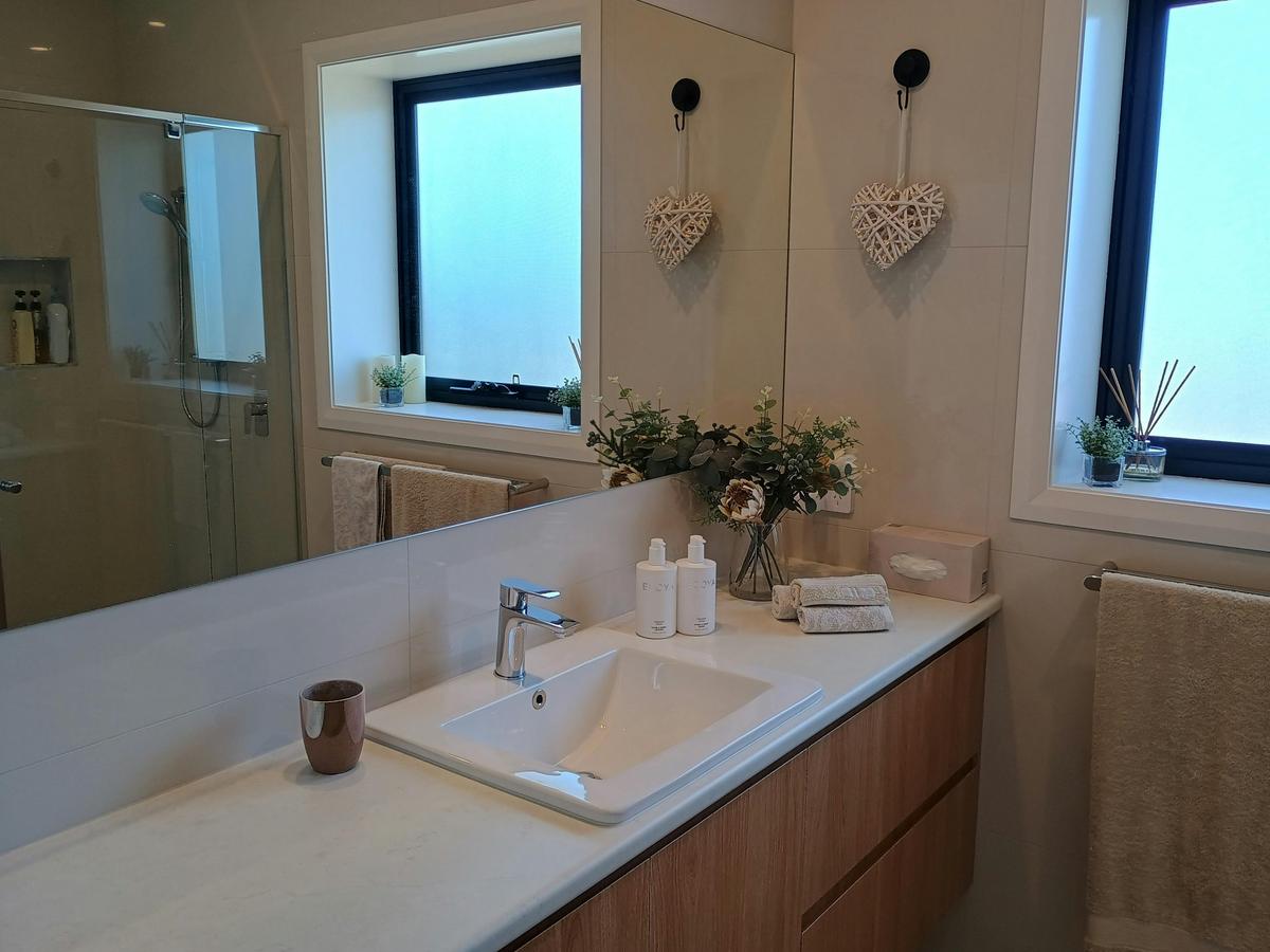 A private ensuite with toiletries on the countertop