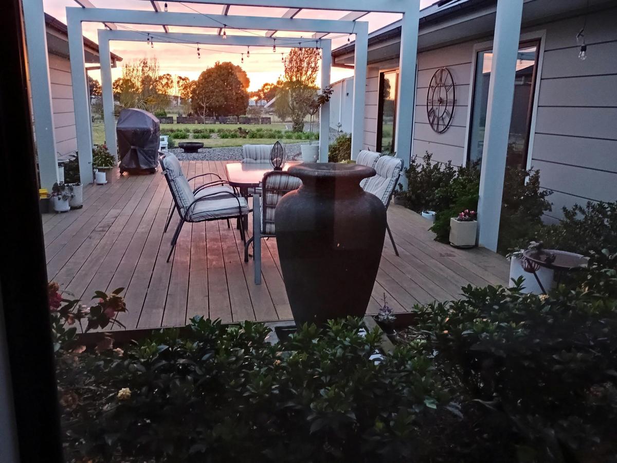 A shared central deck with a sunset setting in the background