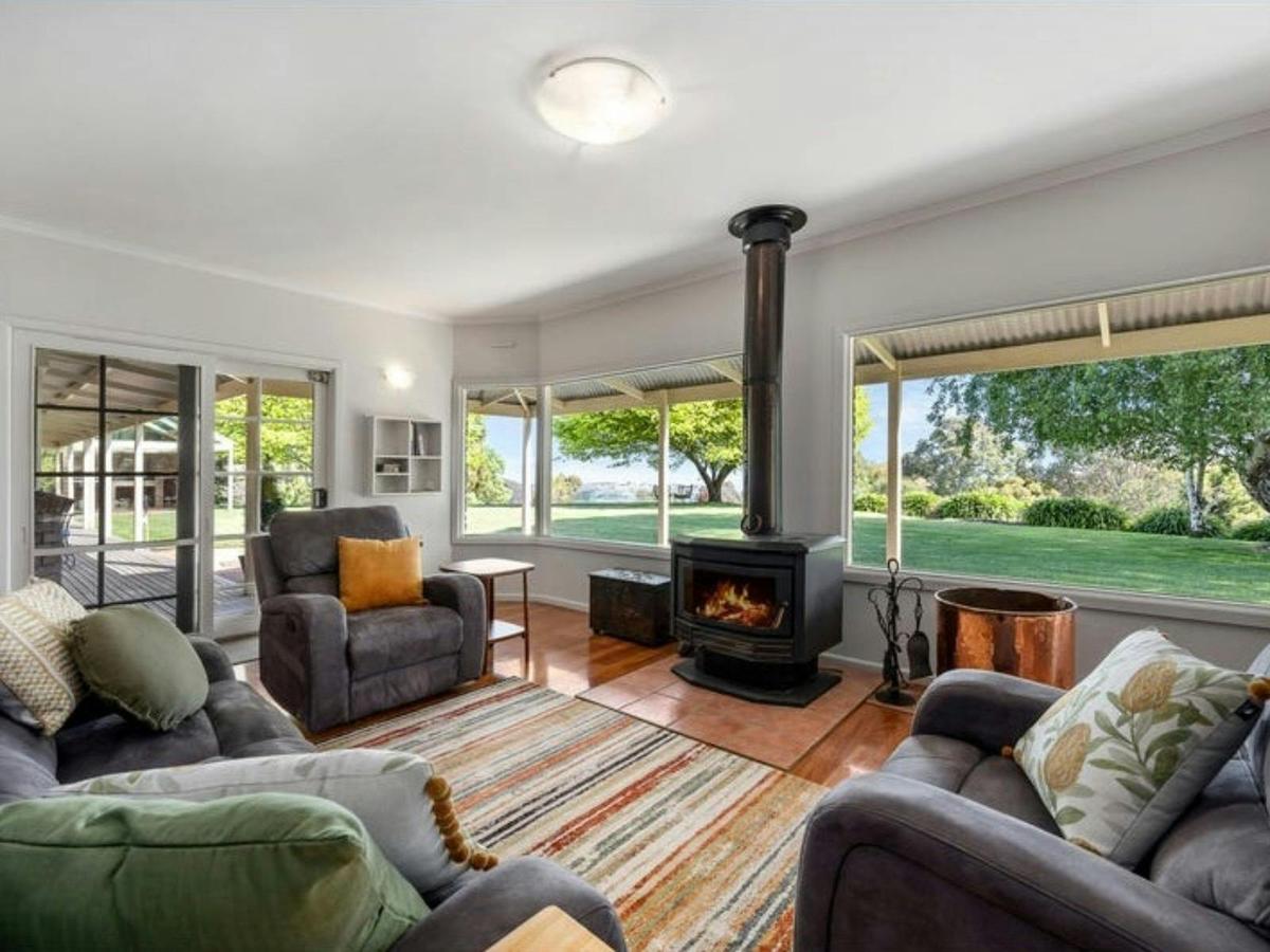 Living area at Sambar Ridge farm stay with comfortable seating and countryside views.
