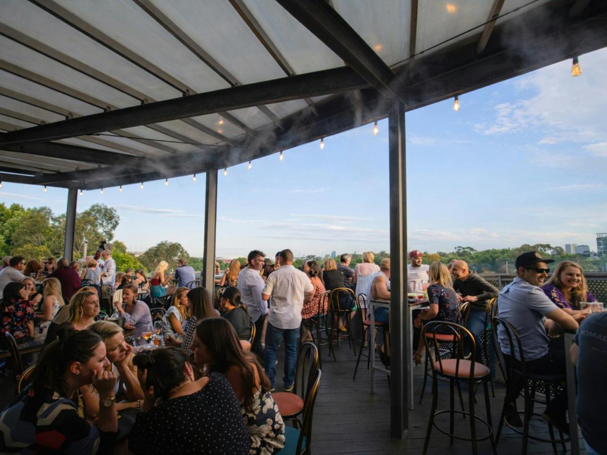 People gathering at Transit Rooftop Bar Outdoor Deck