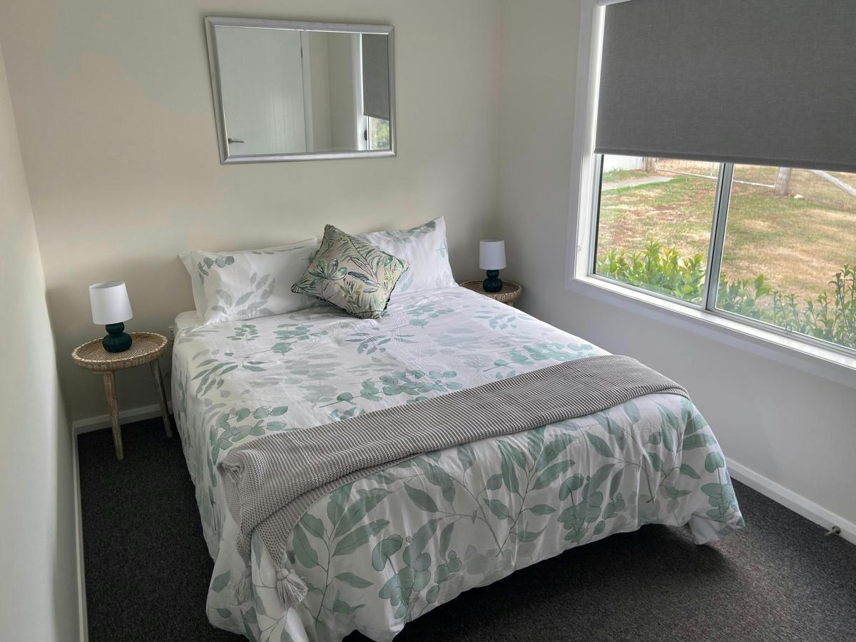 Cosy queen size bed with farm views.