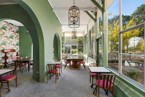 historic room with green walls and tables
