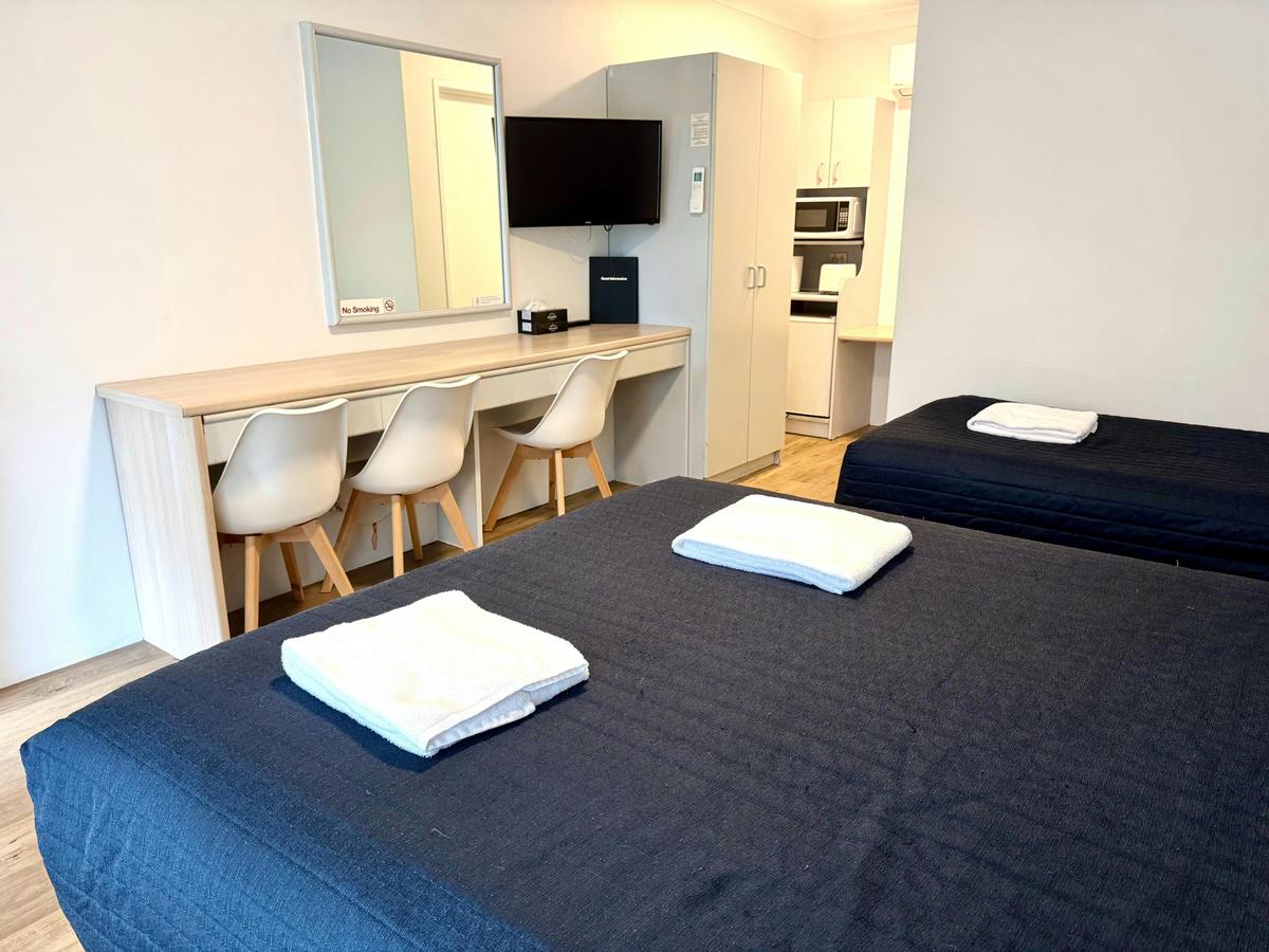 Twin or Triple Room with long desk workspace and quick meal making facilities