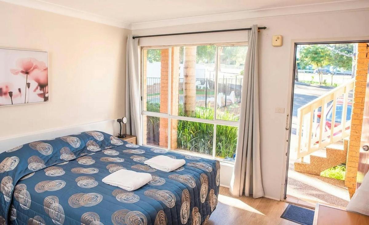 Ground Floor Queen Room with pool view and parking access, offering comfortable, convenient stays