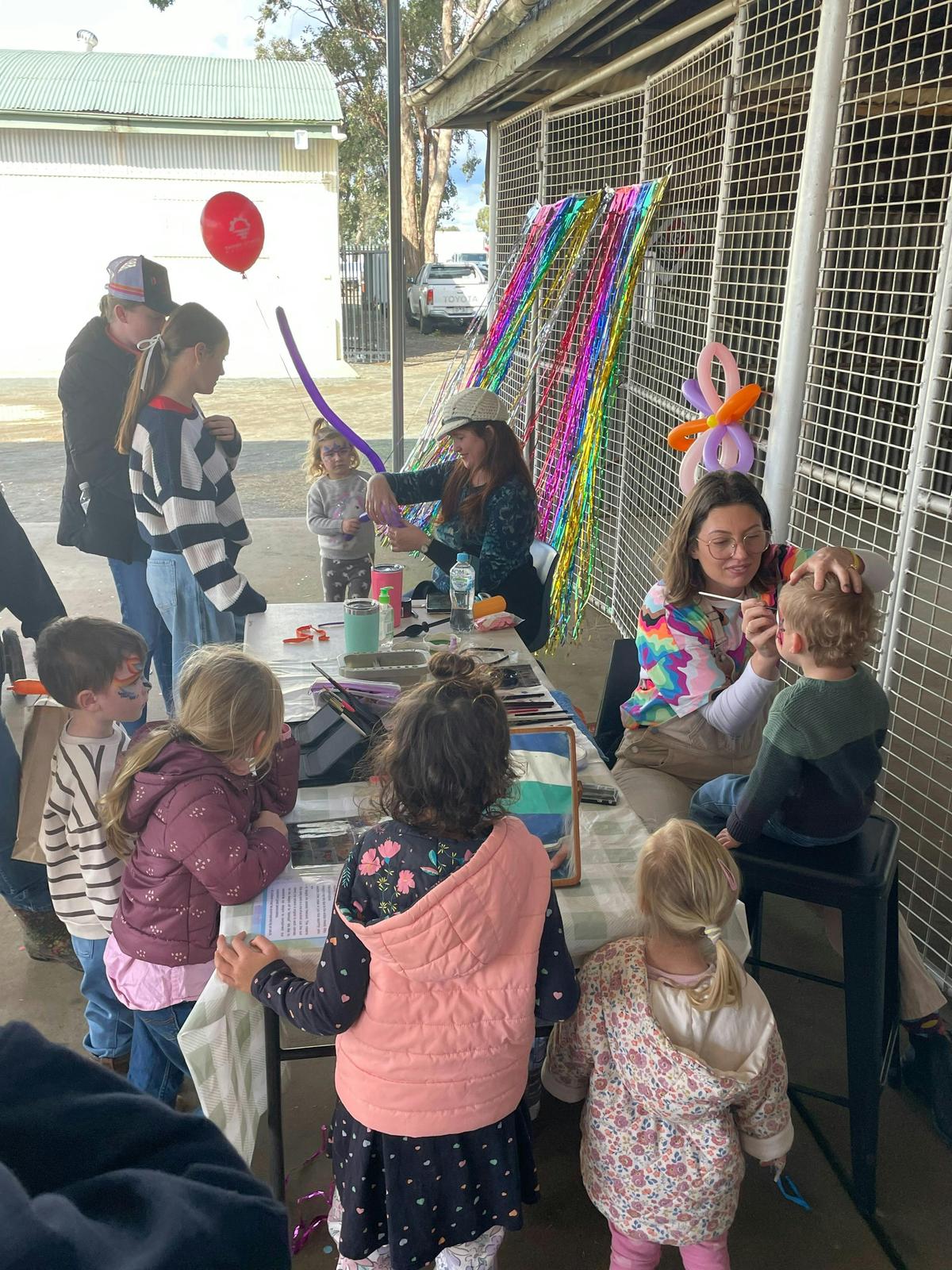 Kids enjoy free activities at the Nyngan Ag Expo, with face painting and balloon twisting creating p